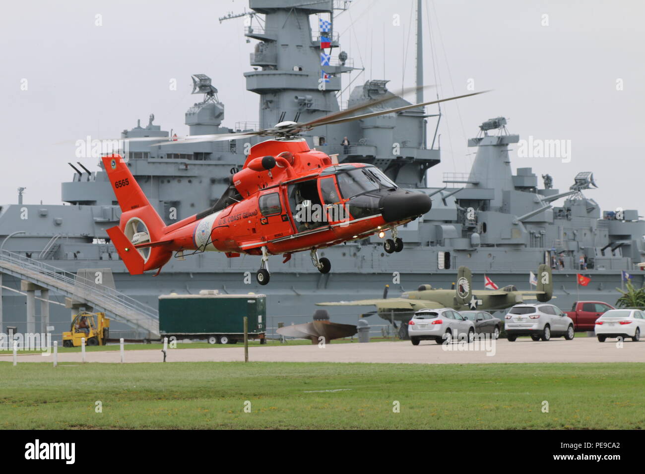 An ATC Mobile MH-65 Dolphin helicopter crew landed at the USS Alabama Battleship Memorial Park for the Fallen Guardians Monument ceremony Nov. 10, 2015. The monument is in honor of Coast Guardsmen that lost their lives serving in Alabama. (U.S. Coast Guard photo by Lt. Jacob Scritchfield) Stock Photo