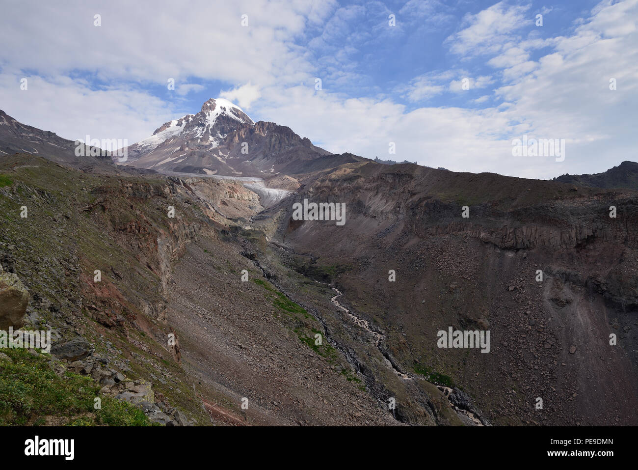 Treking in the mountains of the Large Caucasus. Road for the Kazbek peak. In the background Kazbek peak. Stepantsminda, Georgia Stock Photo