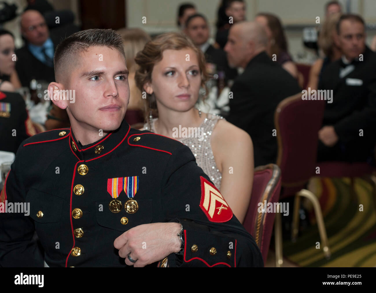 U.S. Marine Corps Cpl. Timothy Turner and his wife Kayla Turner listen