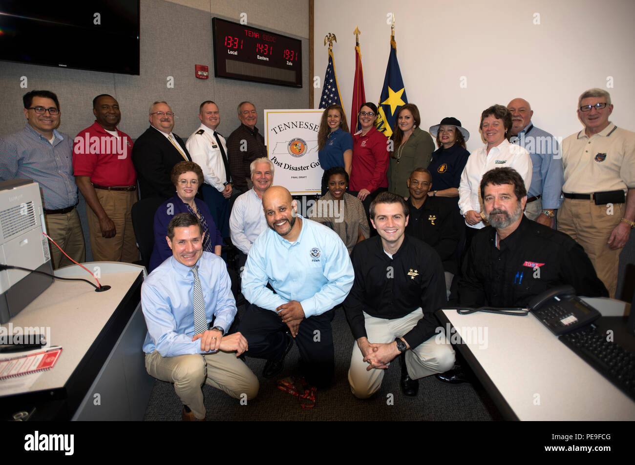 Silver Jackets partners pose together Nov. 17, 2015, during a ceremony at the Tennessee Emergency Management Agency to announce the distribution of the Tennessee Post Disaster Guide to emergency management personnel across the state.  Silver Jackets is an innovative program where multiple state, federal, and sometimes tribal and local agencies learn from each other and apply knowledge to reduce risk to natural hazards.  Program goals include improved communication, facilitation of actions to reduce vulnerability and consequences of flooding, creation or supplement of mechanisms to implement or Stock Photo