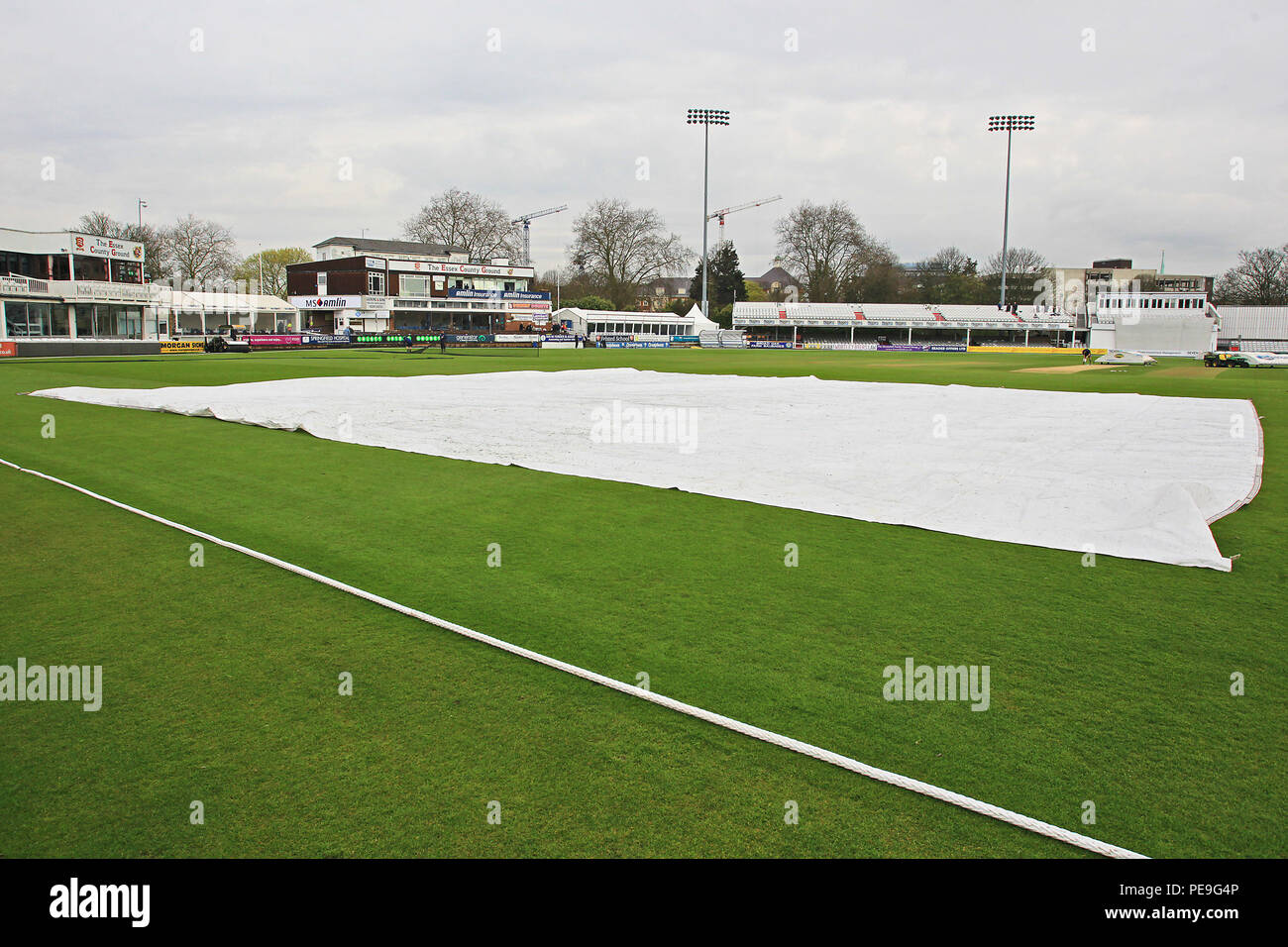 The covers are on the outfield as rain delays the start of Essex CCC vs Gloucestershire CCC, Specsavers County Championship Division 2 Cricket at the  Stock Photo