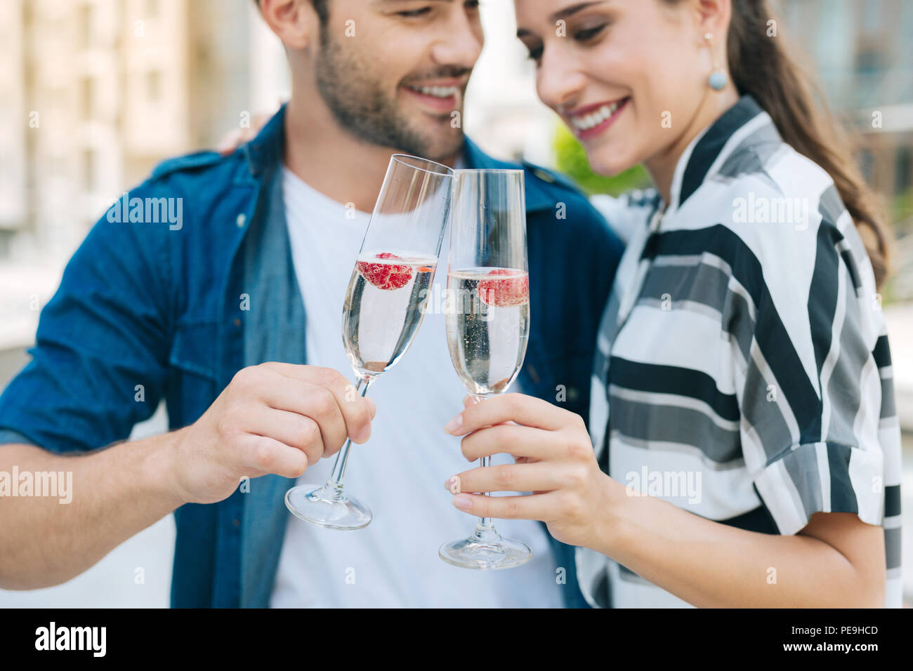 Glasses with champagne being clinked together Stock Photo