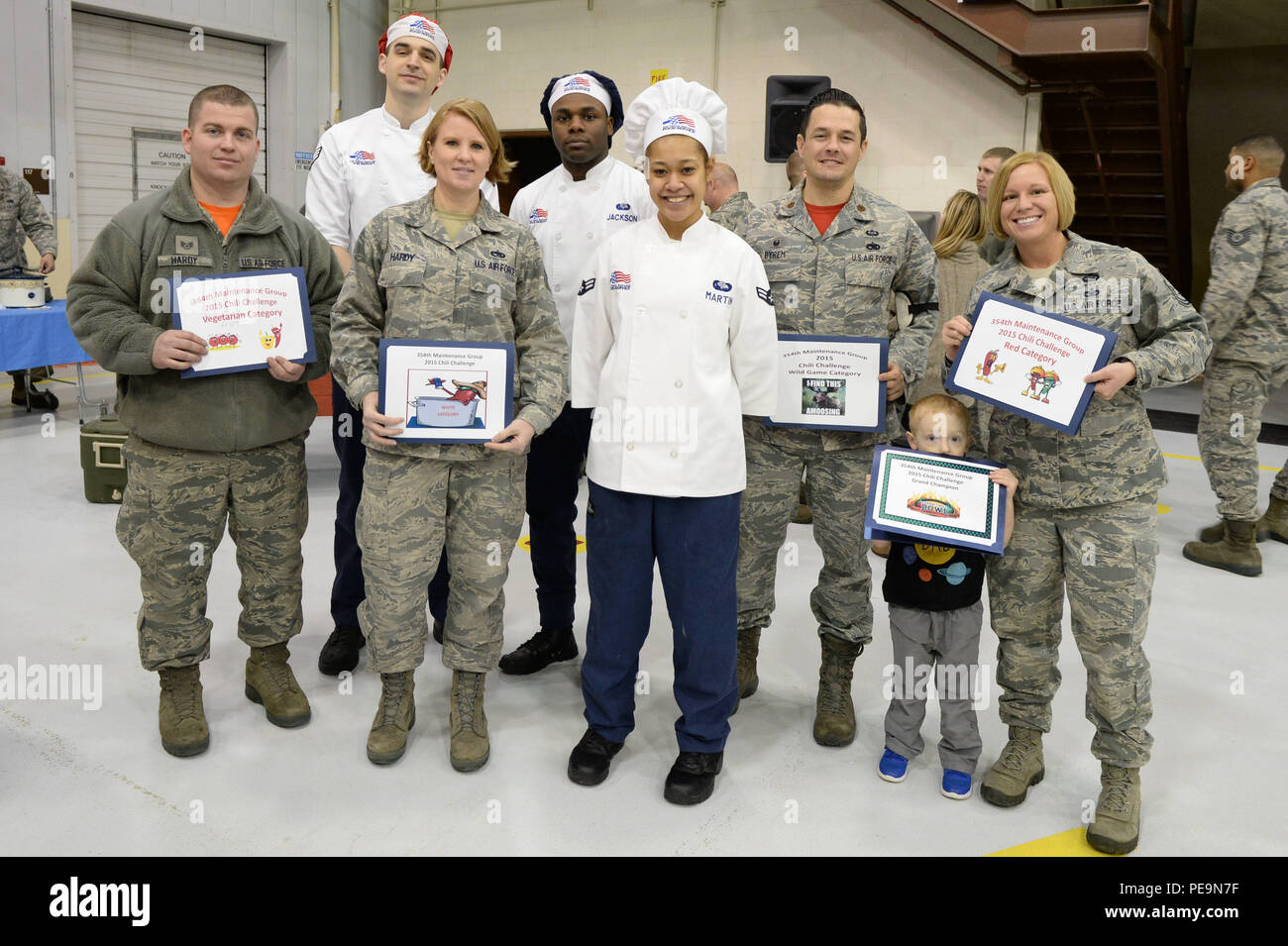 Winners of the 354th Maintenance Group chili cook off stand with judges