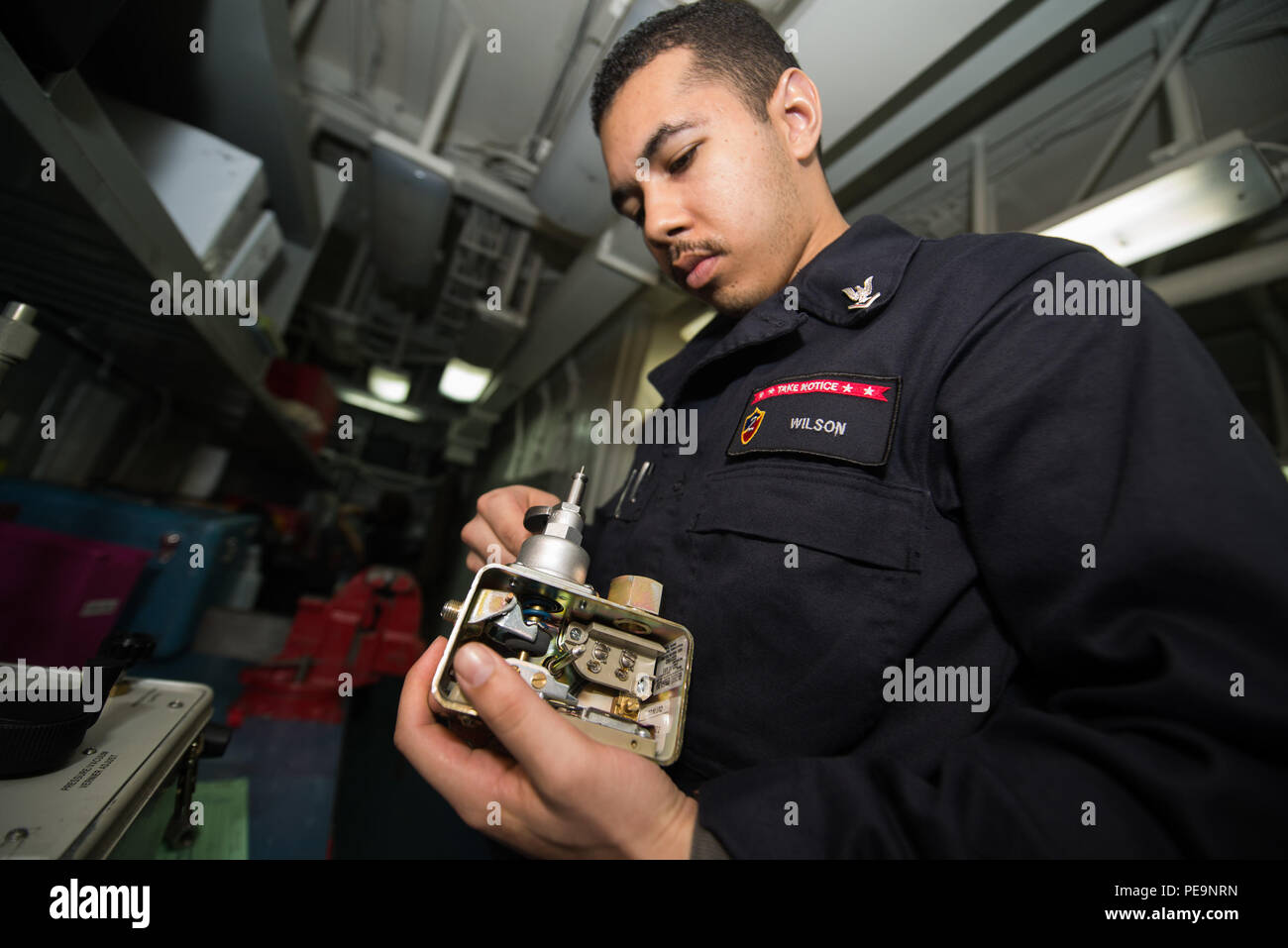 PACIFIC OCEAN (Nov. 25, 2015) Machinist's Mate 3rd Class Keanu Wilson  reassembles a pressure switch in the aviation calibration lab aboard the  Wasp-class amphibious assault ship USS Essex (LHD 2). Essex is