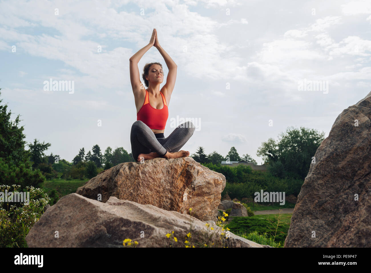 Yoga woman breathing slowly while practicing sitting posture Stock Photo