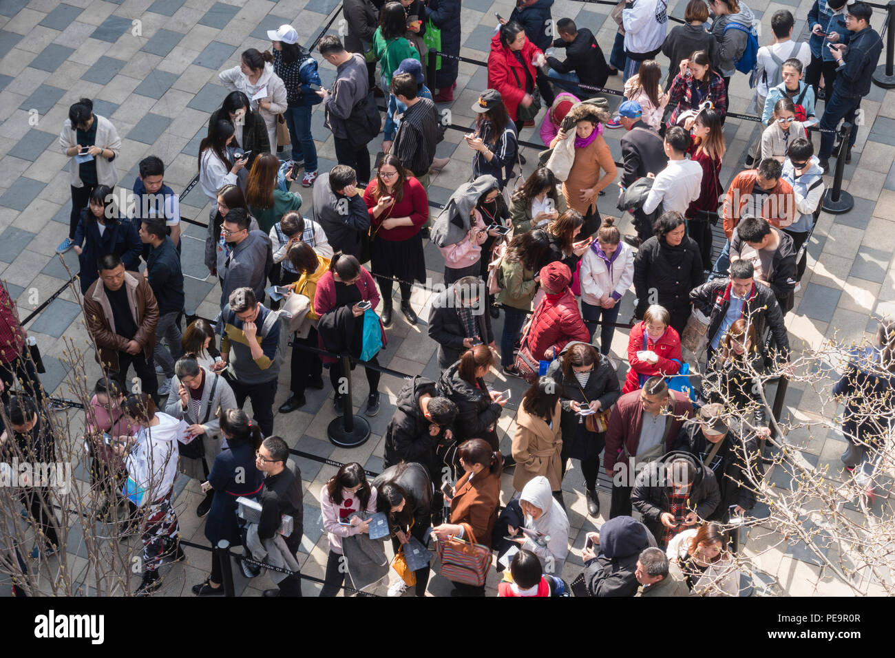 People queuing up for an event in a shopping mall in Beijing Stock Photo