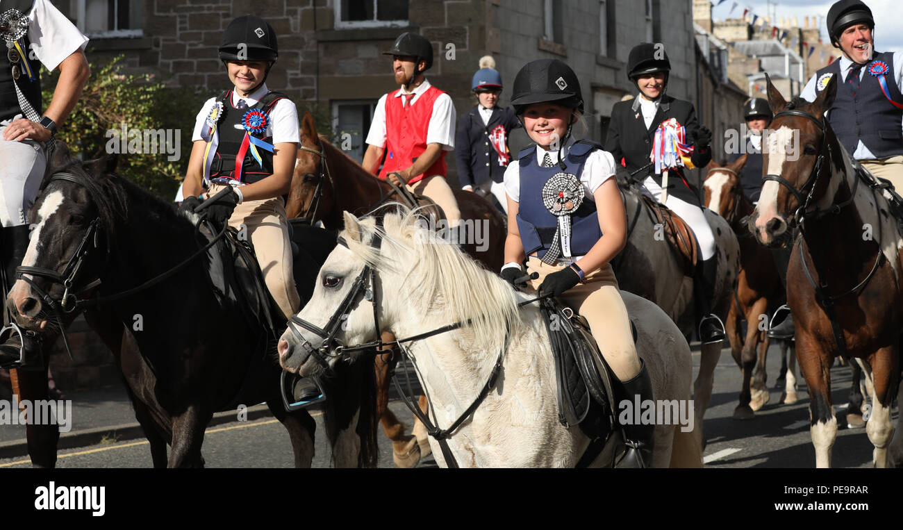 Part of the cavalcade returning after the Flodden Rideout during Coldstream Civic Week Stock Photo