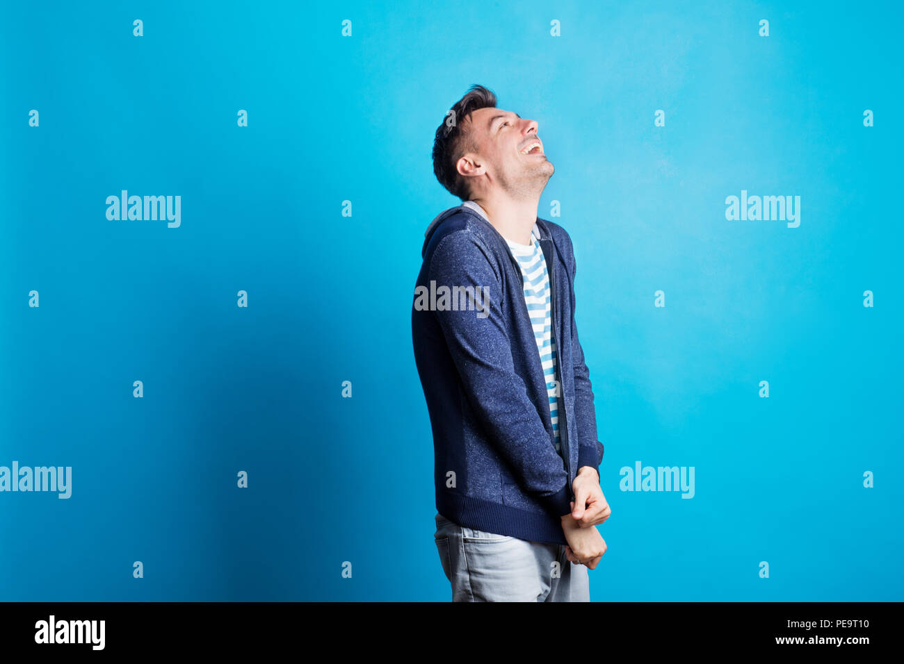 Studio portrait blue background happy hi-res stock photography and ...
