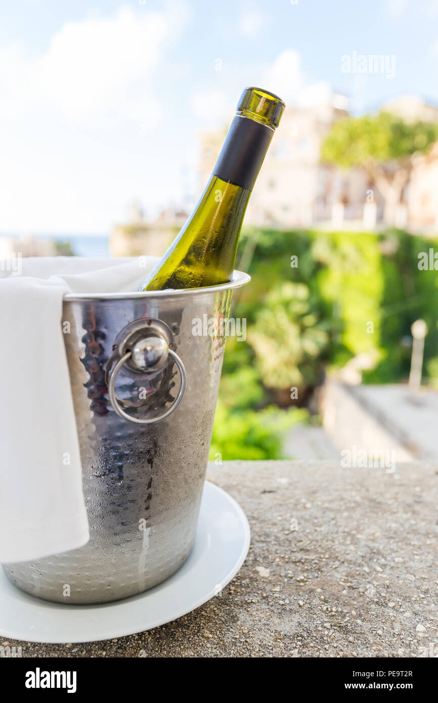 a bottle of wine in an ice bucket in the open area of restaurante Stock