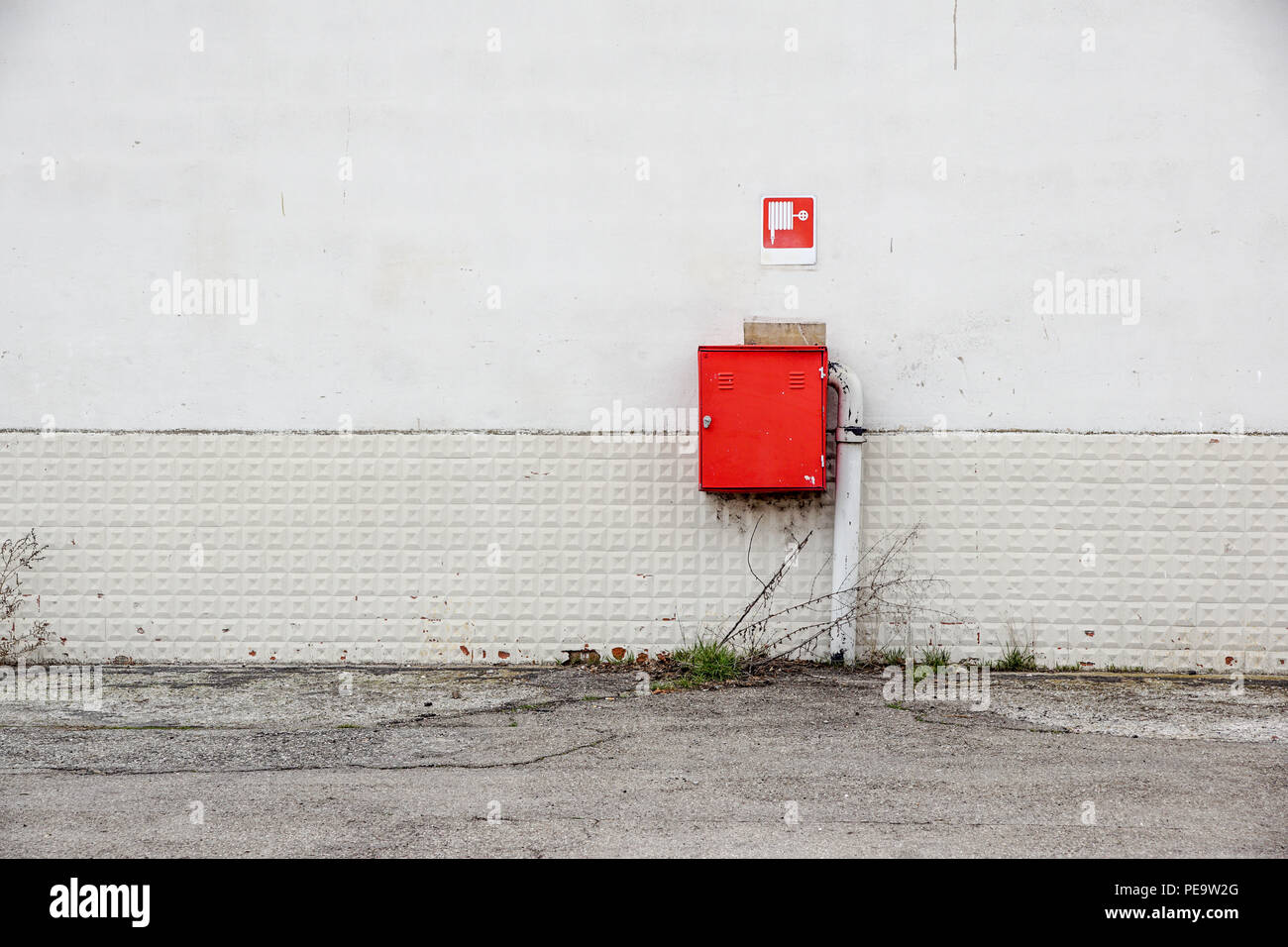 an fire hose hanging on the wall Stock Photo