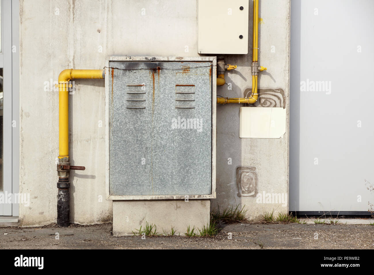 Industrial gas meter yellow box and pipes Stock Photo