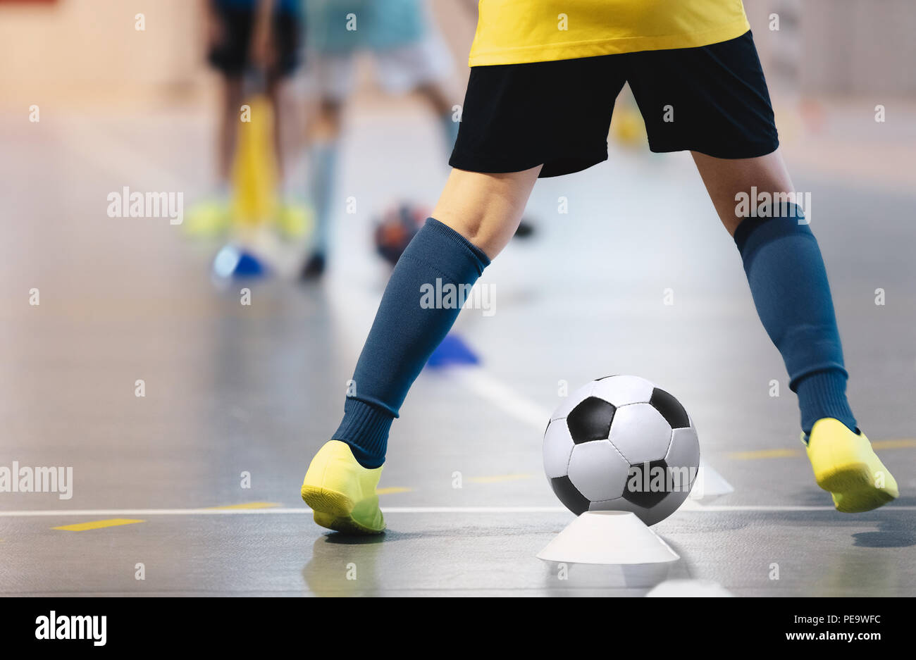 Indoor soccer players training with balls. Indoor soccer sports hall. Football futsal player, ball, futsal floor. Sports background. Futsal league. In Stock Photo