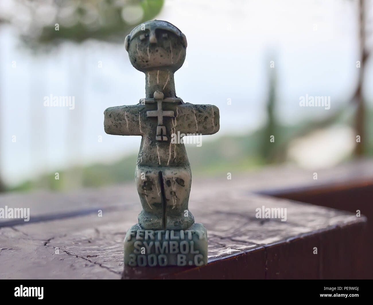 Idol of Pomos, ancient symbol of fertility on Cyprus. A small sculpture on a blurred background. Traditional souvenir for tourists Stock Photo