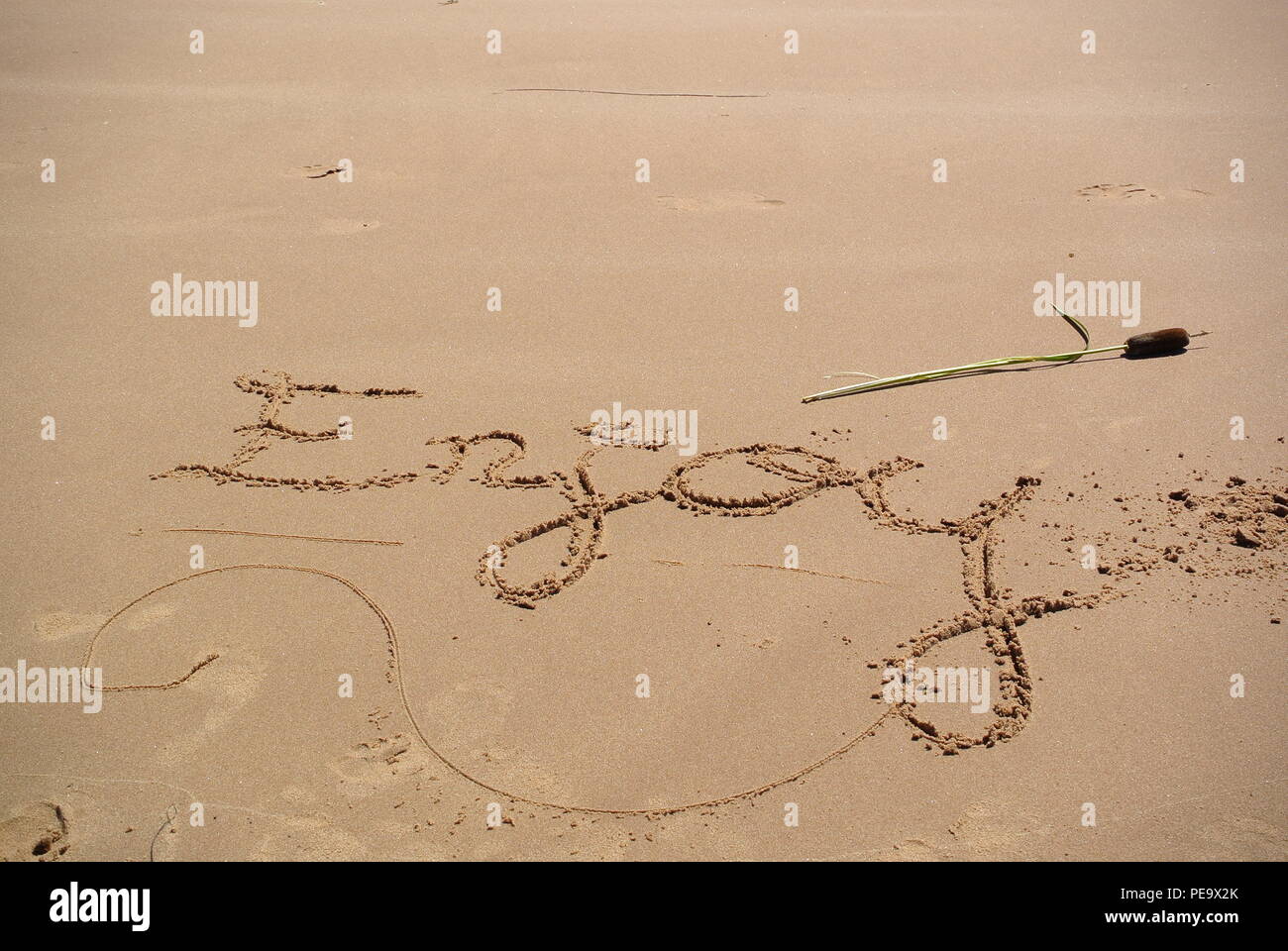 Handwritten, beautiful message '' written on the red sand on a beach in Prince Edward Island, Canada Stock Photo