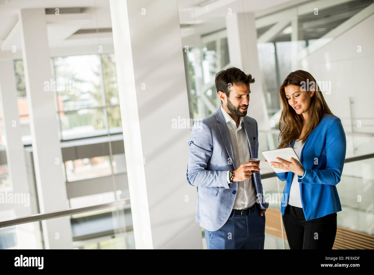 Portrait of young business people standing in the office Stock Photo ...