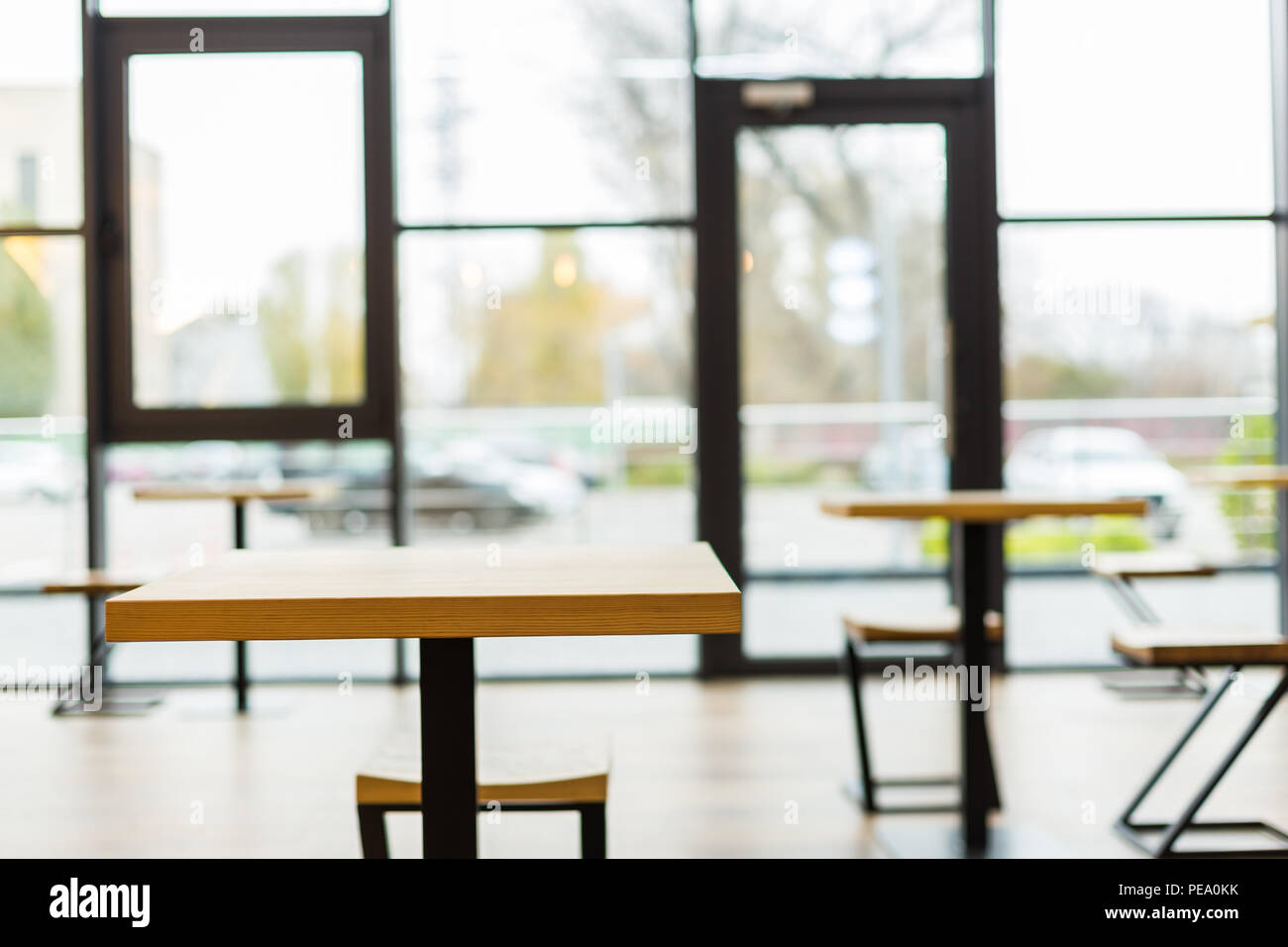 No visitors. Close up of an empty table in the cafeteria with a big glass wall in the background Stock Photo