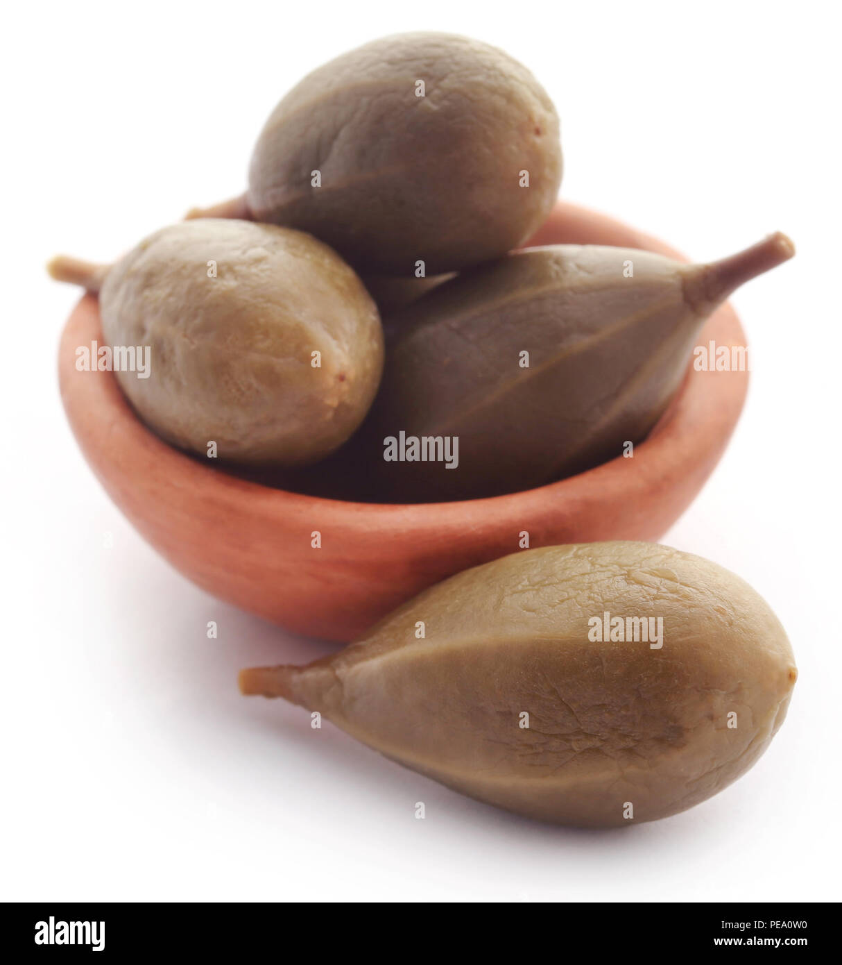 Caper berry in a bowl over white background Stock Photo Alamy