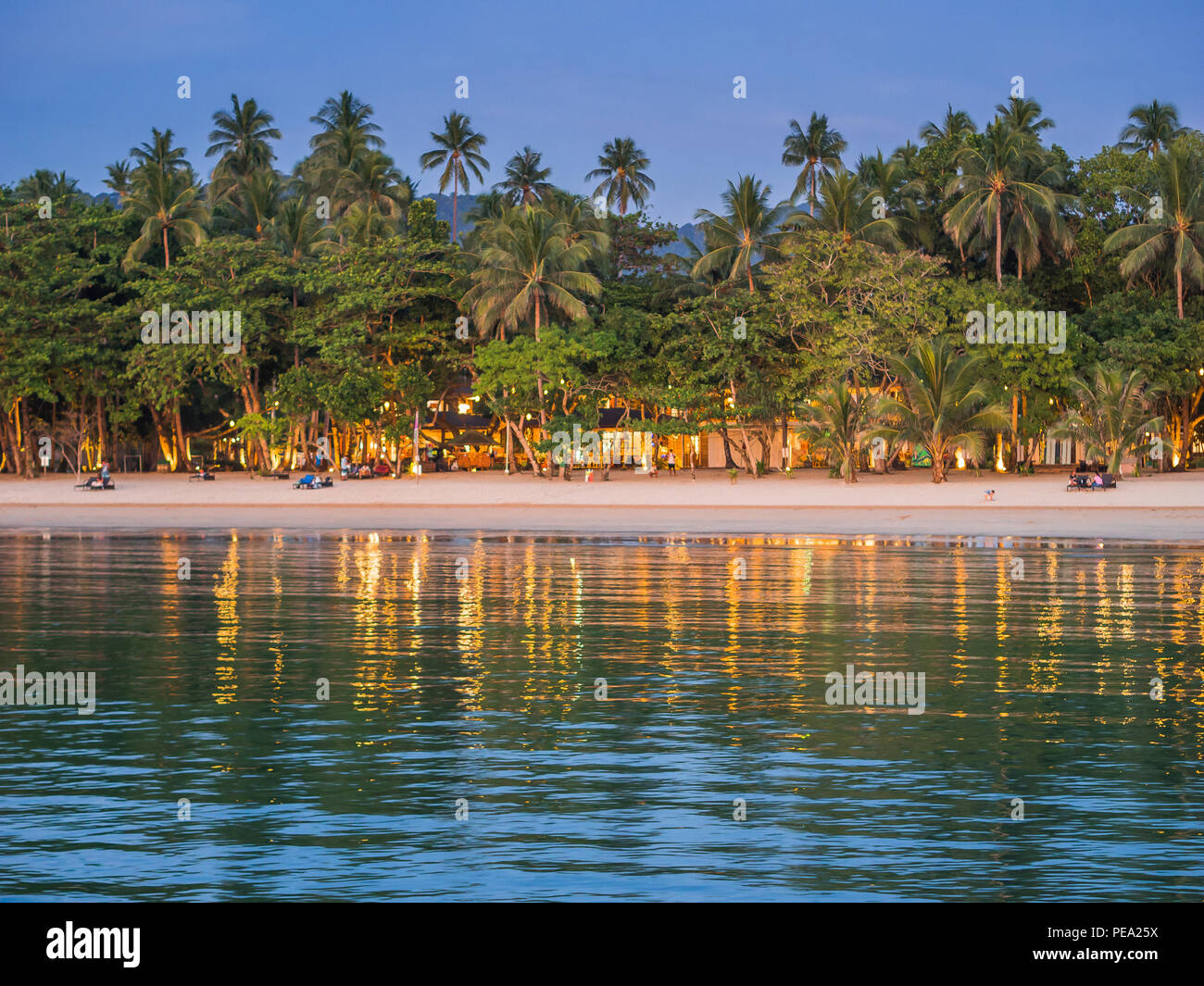 Lio beach luxury resort on the beach at dusk, people relaxing on the beach looking at sunset Stock Photo