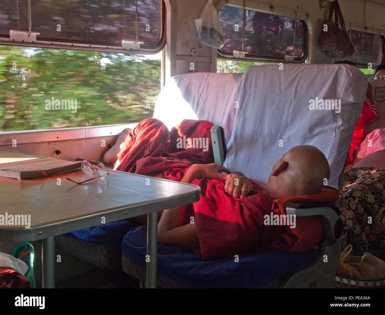 BUDDHIST MONK SLEEPING ON A TRAIN ,MYANMAR ,BURMA Stock Photo Alamy