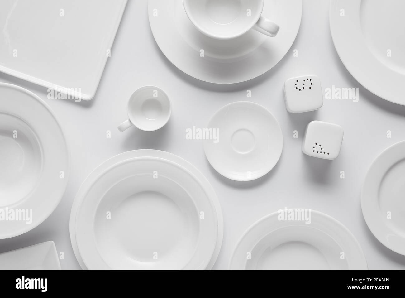 top view of different plates, bowl, saltcellar, pepper caster and cup