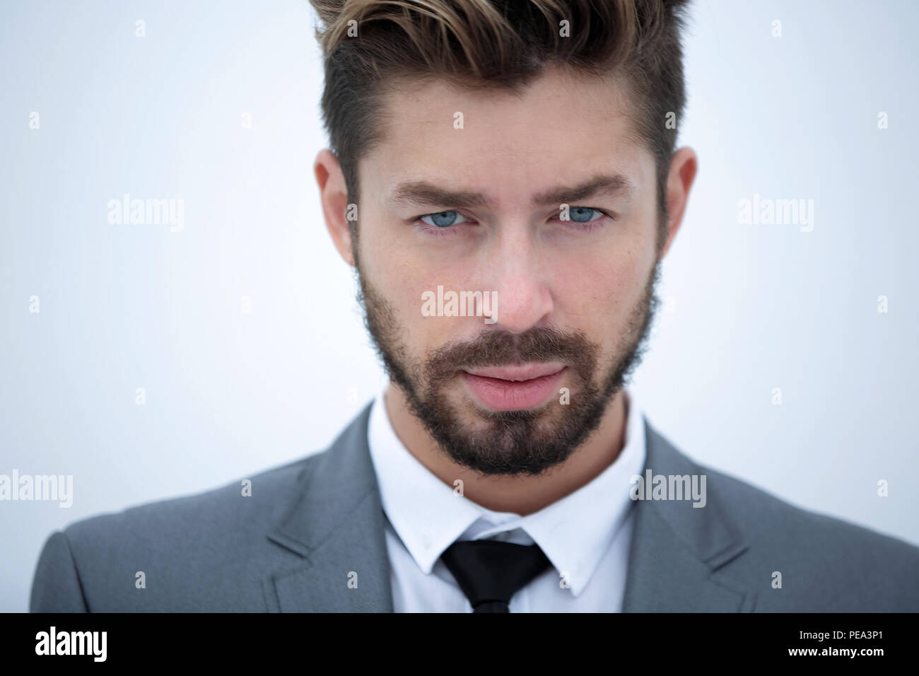 Serious businessman wearing suit and tie. blue background Stock Photo ...