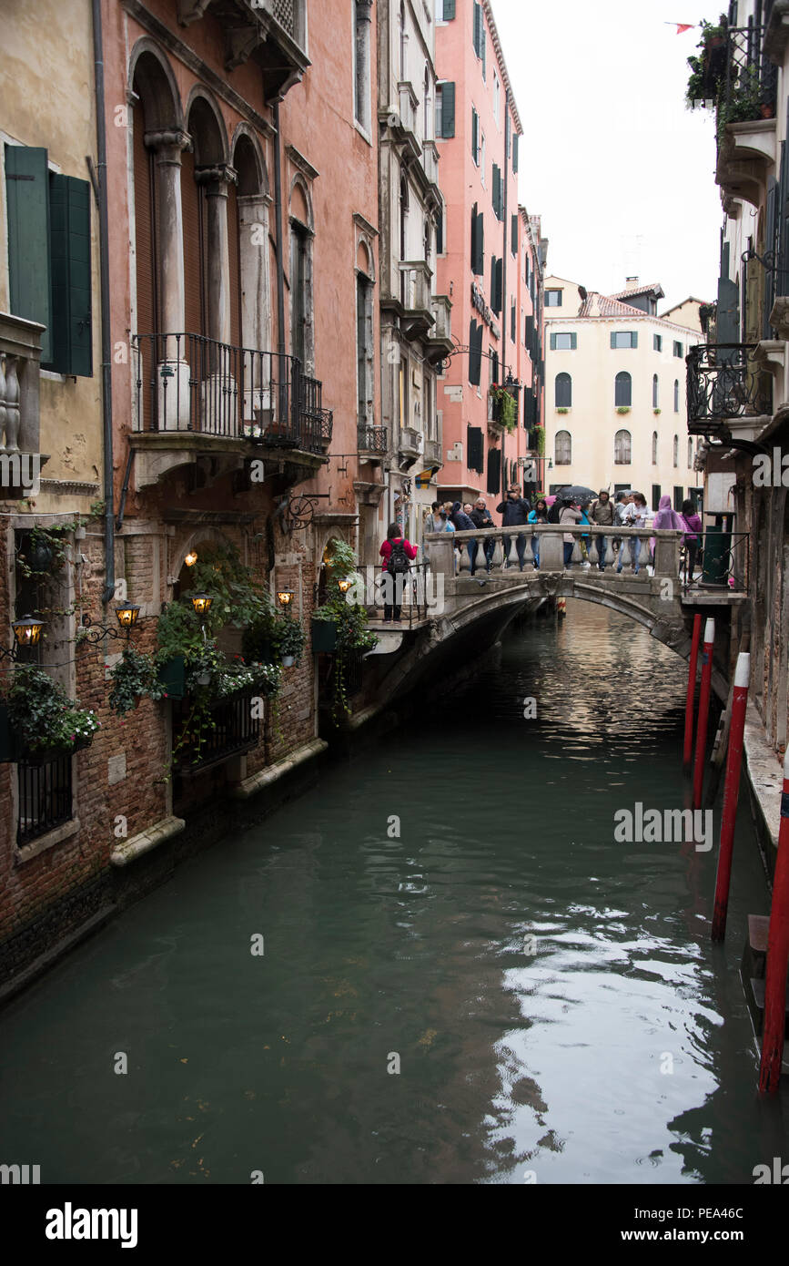 Bridge over a canal that runs below the windows of Trattoria Sempione restaurant, Venice Stock Photo