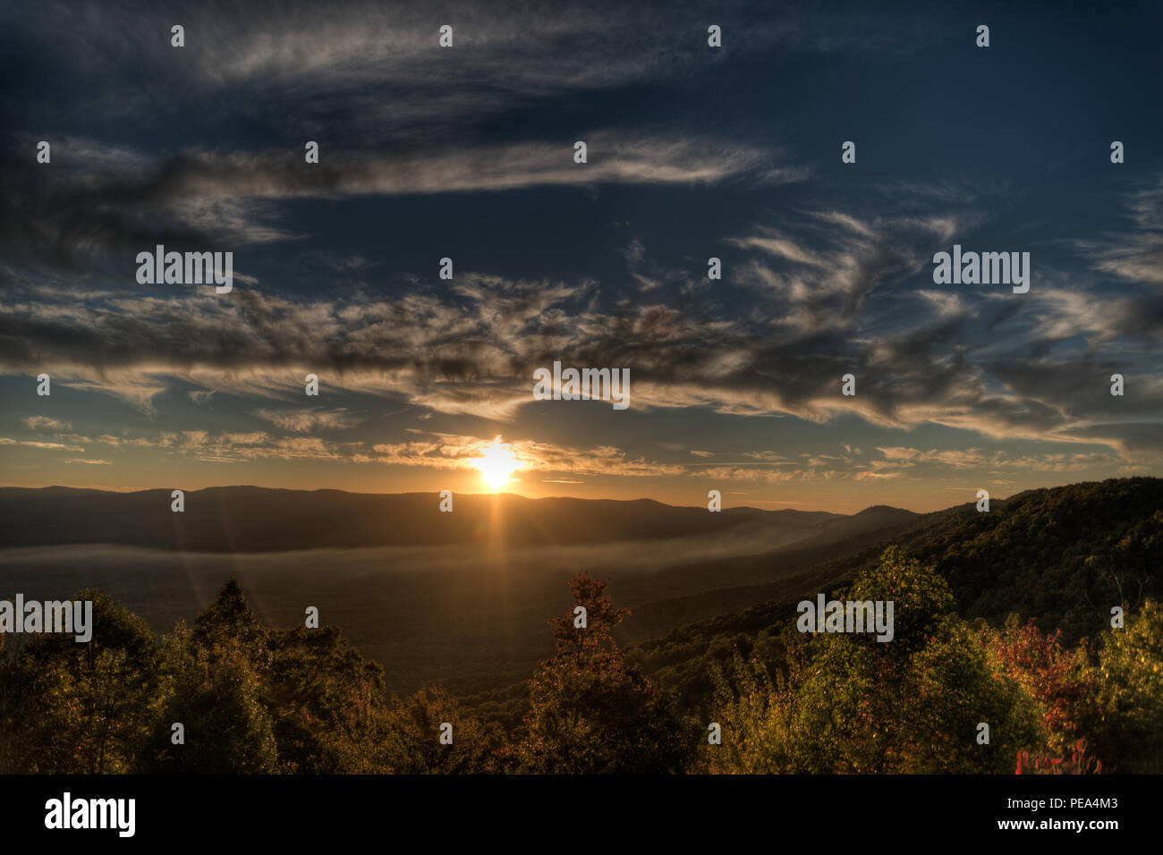 Beautiful sunset over a scenic mountain landscape Stock Photo - Alamy
