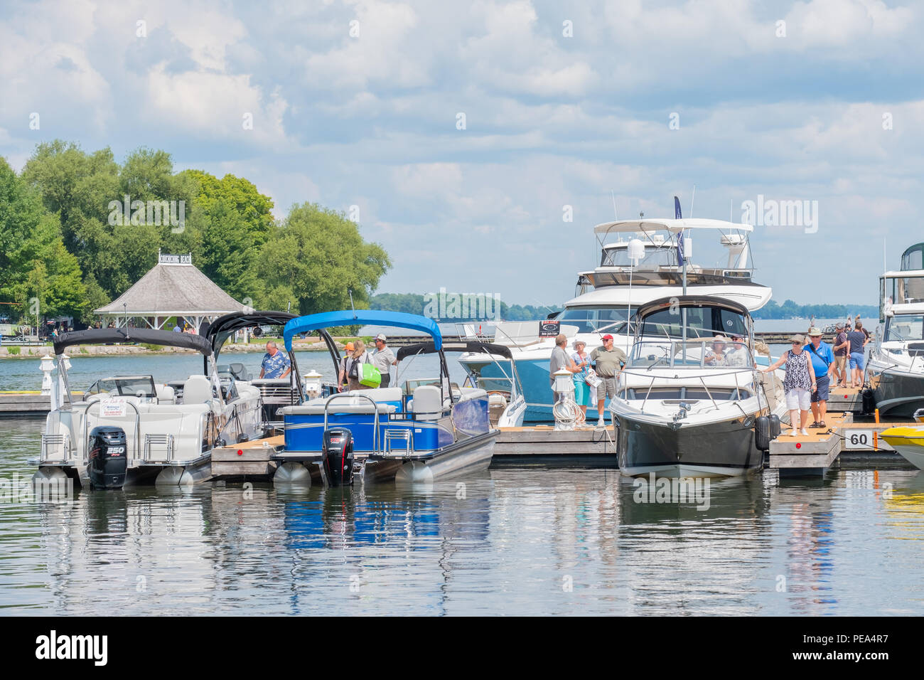 Boating enthusiasts checking out the wide array of boats on display and for sale at the Waterfront Festival and Boat Show in Orillia Ontario. Stock Photo