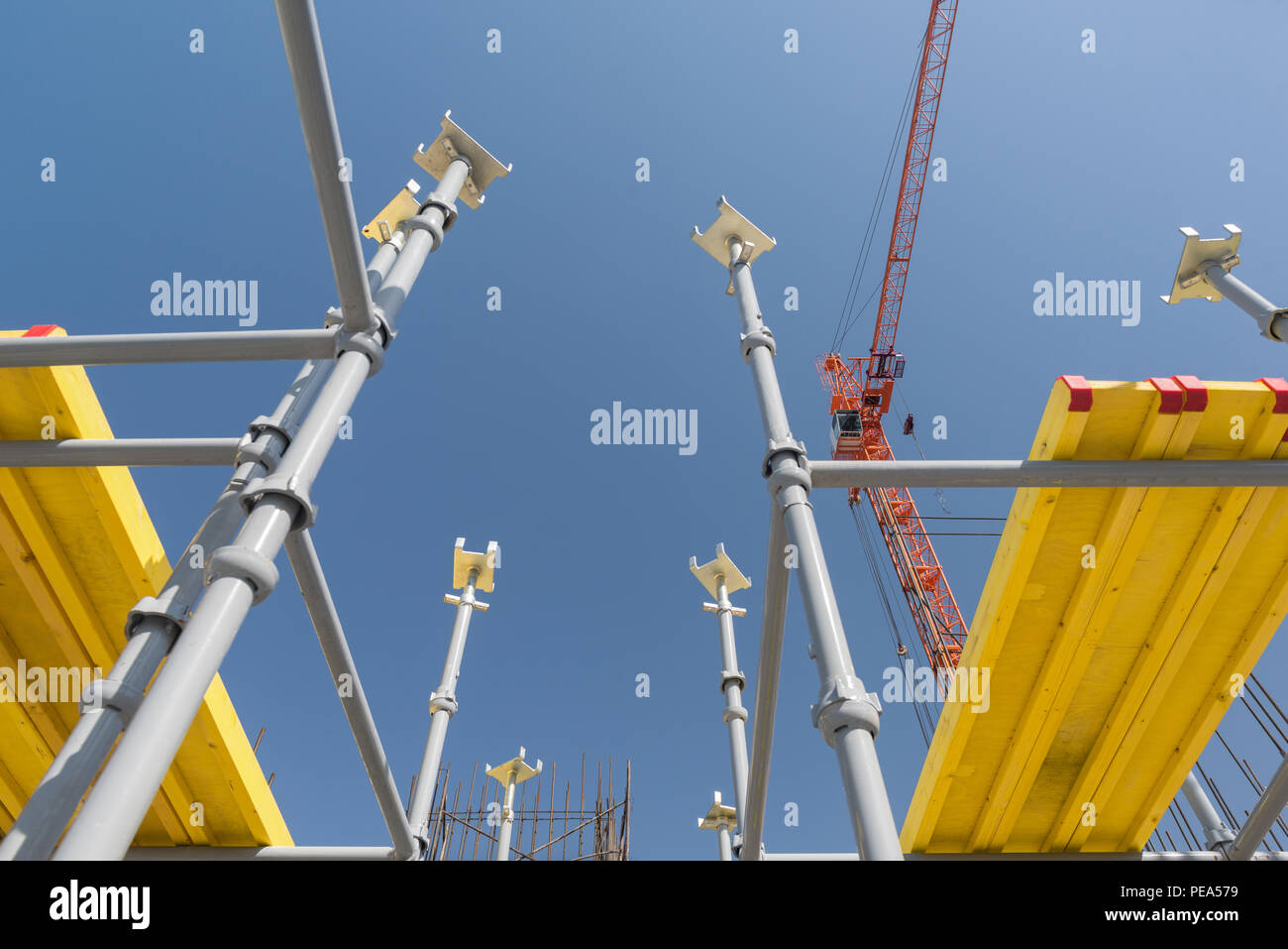 metal concrete structures of the building under construction. scaffolding and supports on a crane background. bottom view Stock Photo
