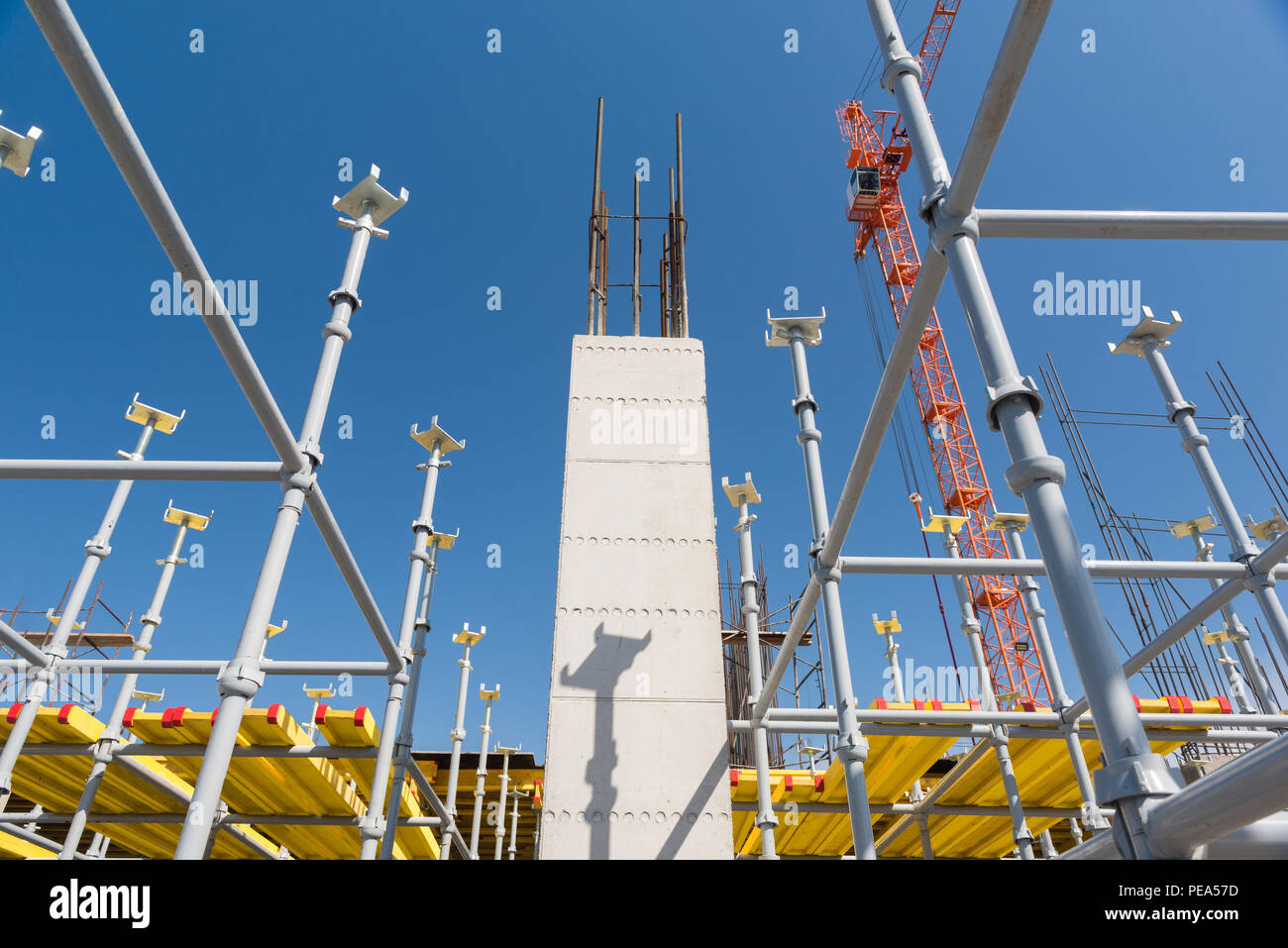 metal concrete structures of the building under construction. scaffolding and supports on a crane background. bottom view Stock Photo