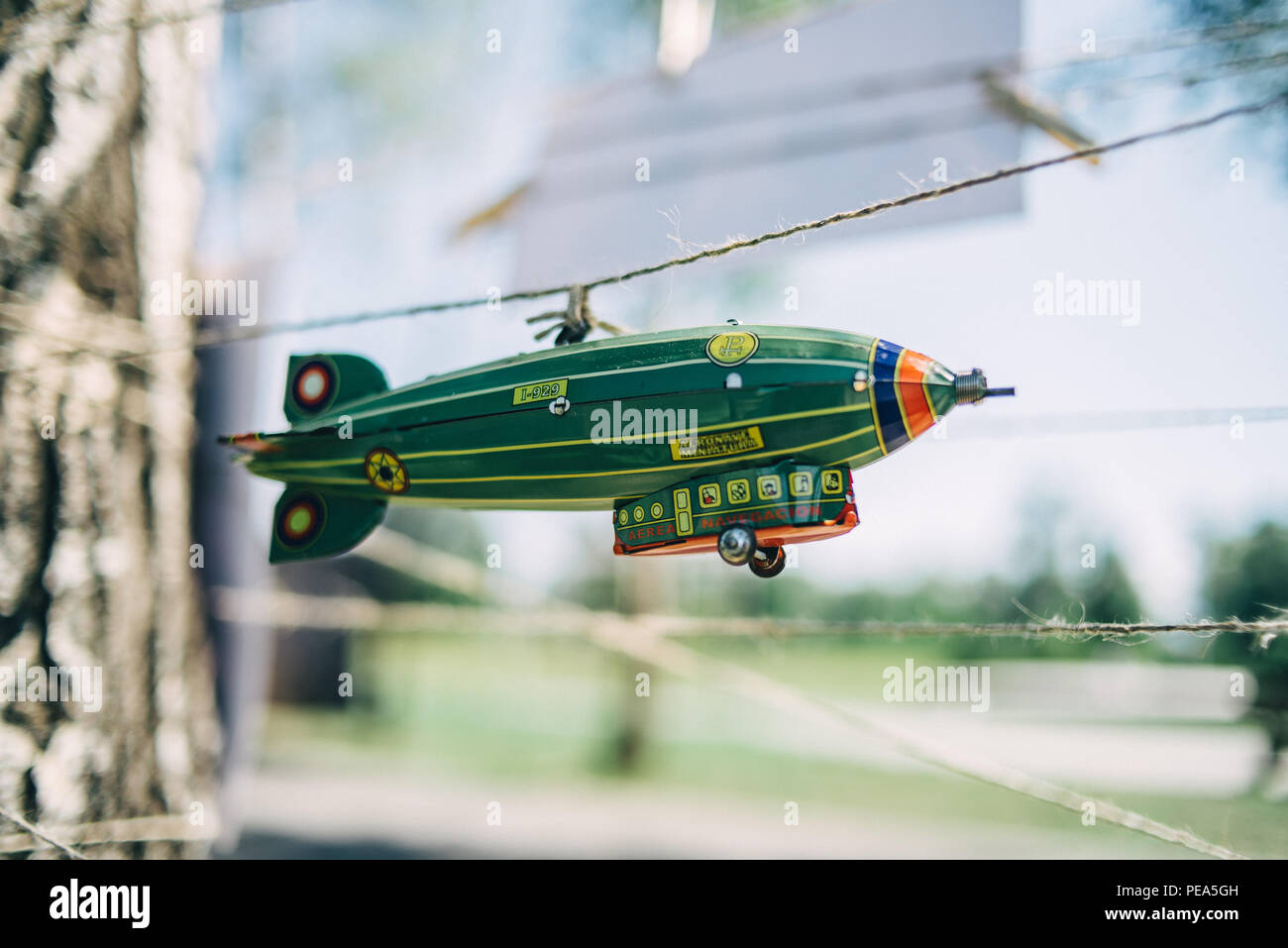 A toy airship hangs on a string Stock Photo