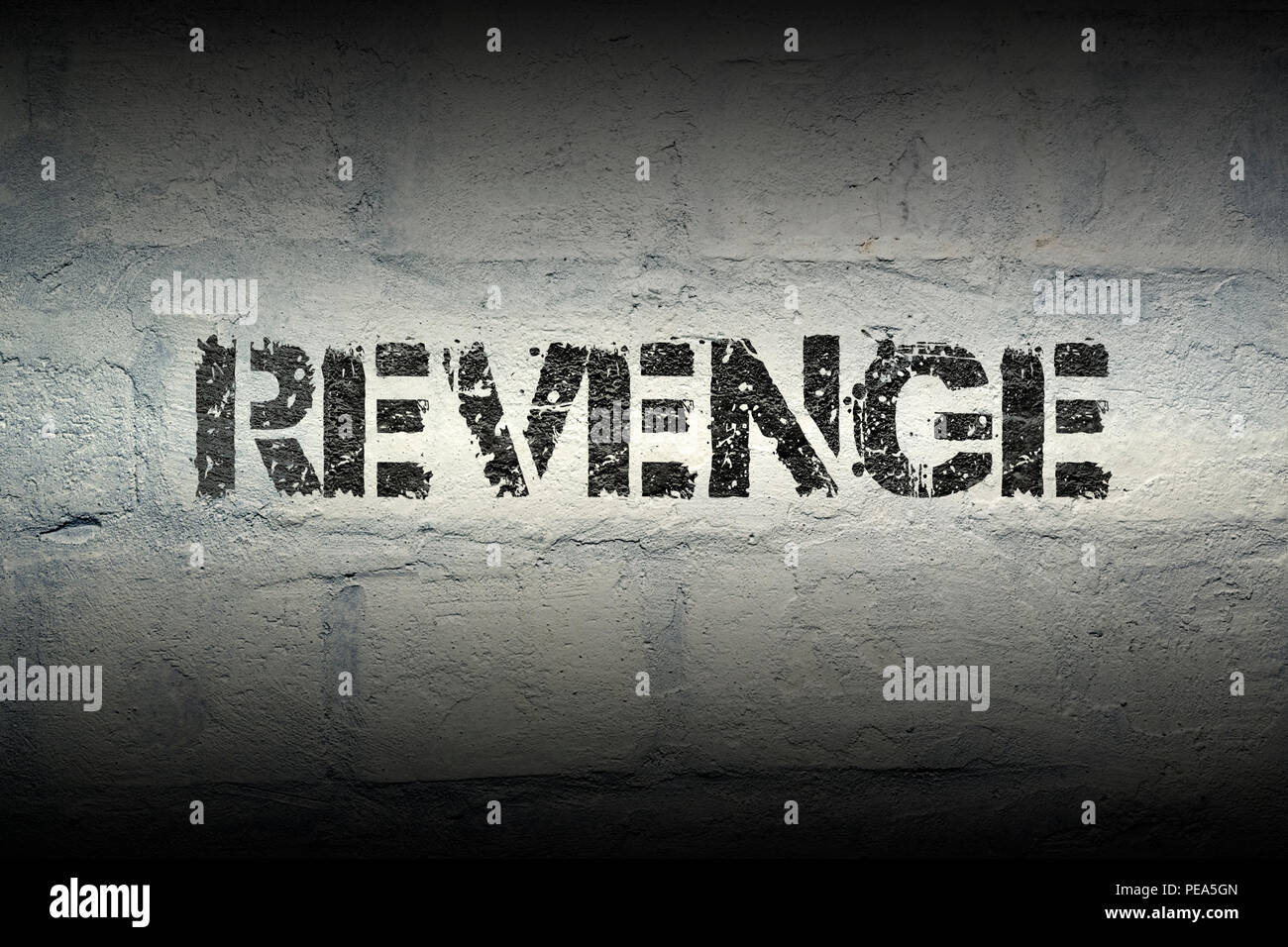revenge stencil print on the grunge white brick wall Stock Photo