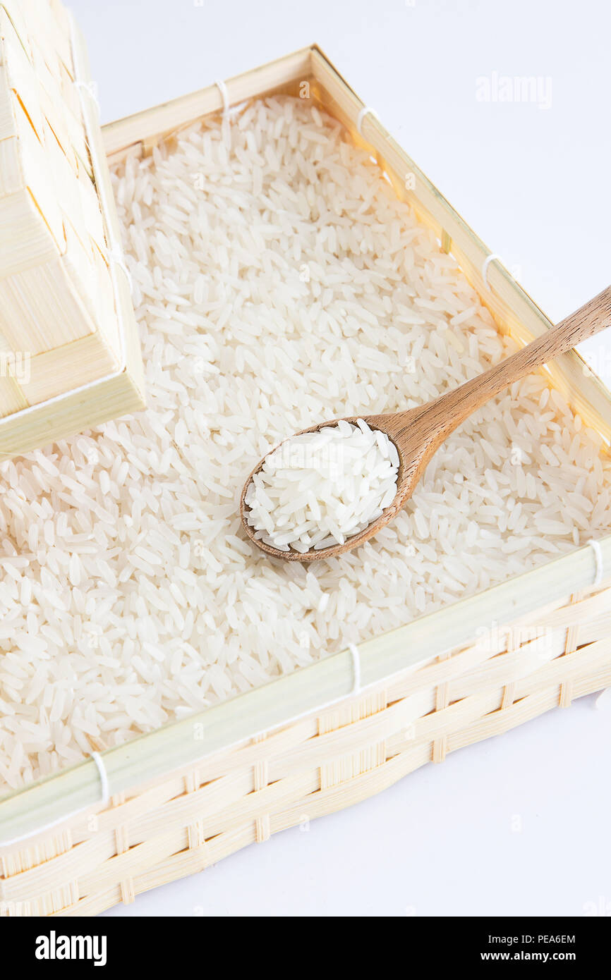 Raw and uncooked rice in wooden spoon,shallow Depth of Field,Focus on wooden spoon Stock Photo