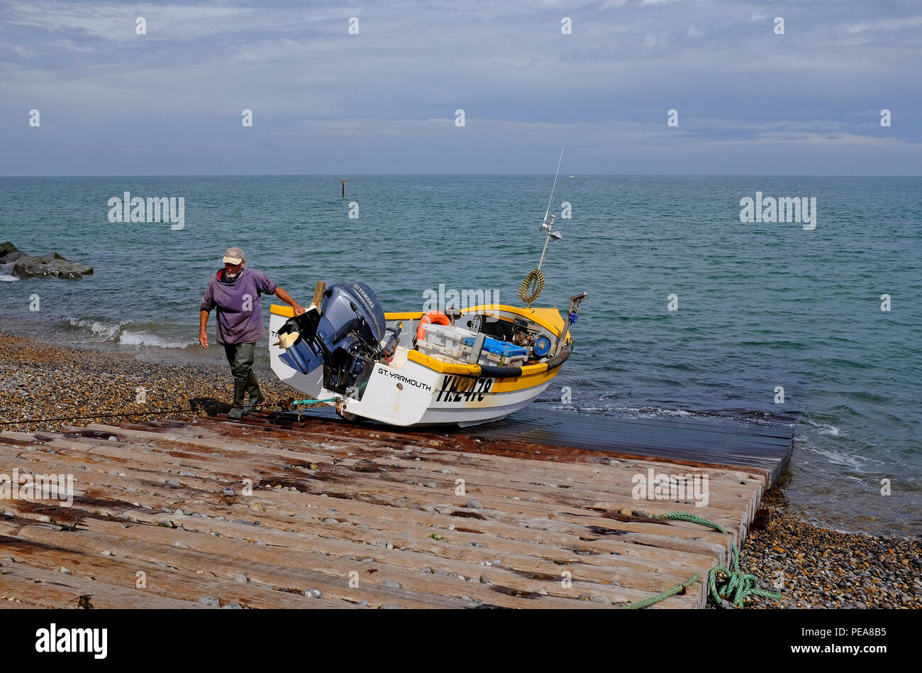 fisherman and fishing boat on slipway, sheringham, north norfolk, england Stock Photo