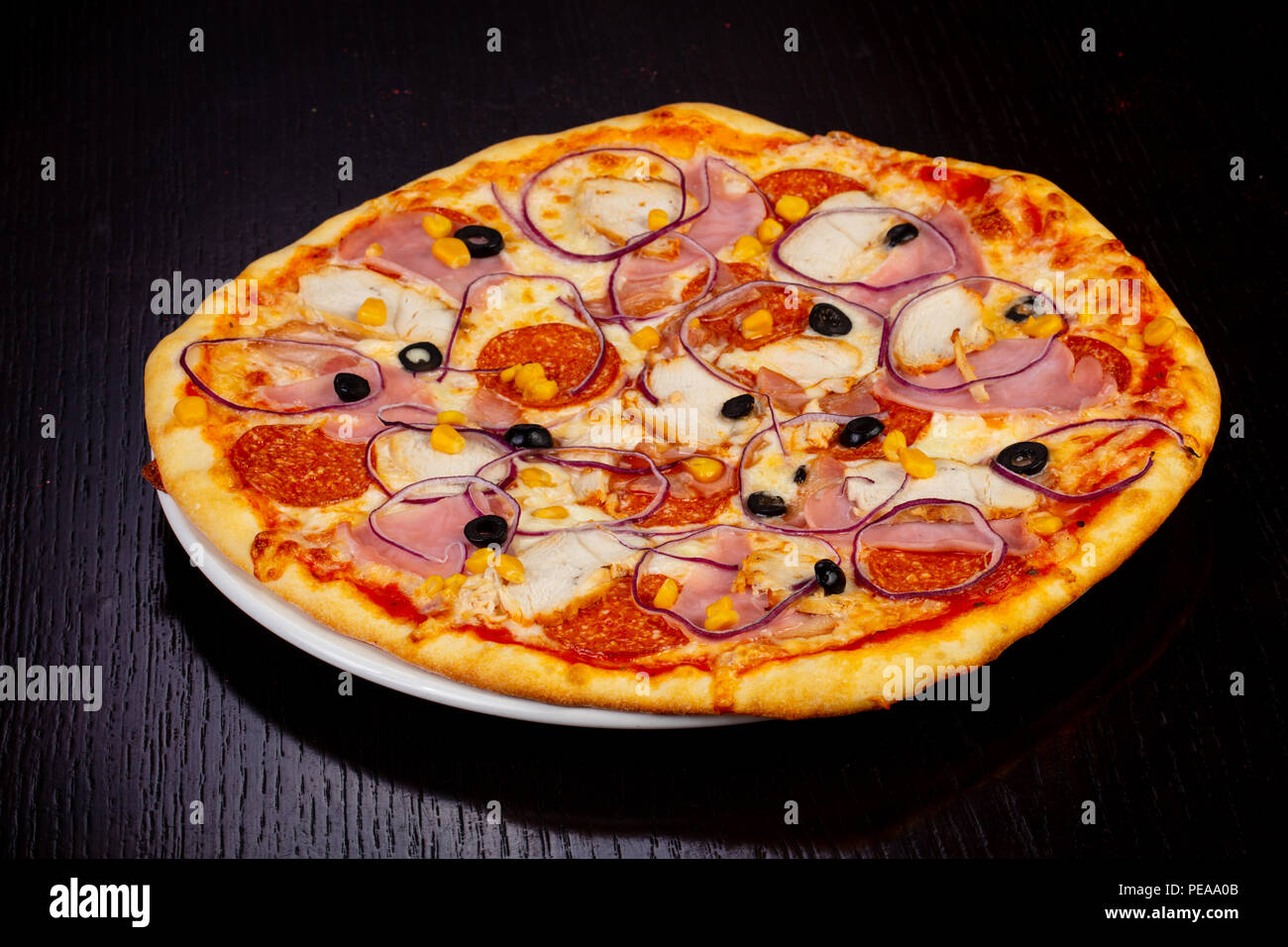 Delicious meat pie pizza with salami, ham and onions Stock Photo Alamy