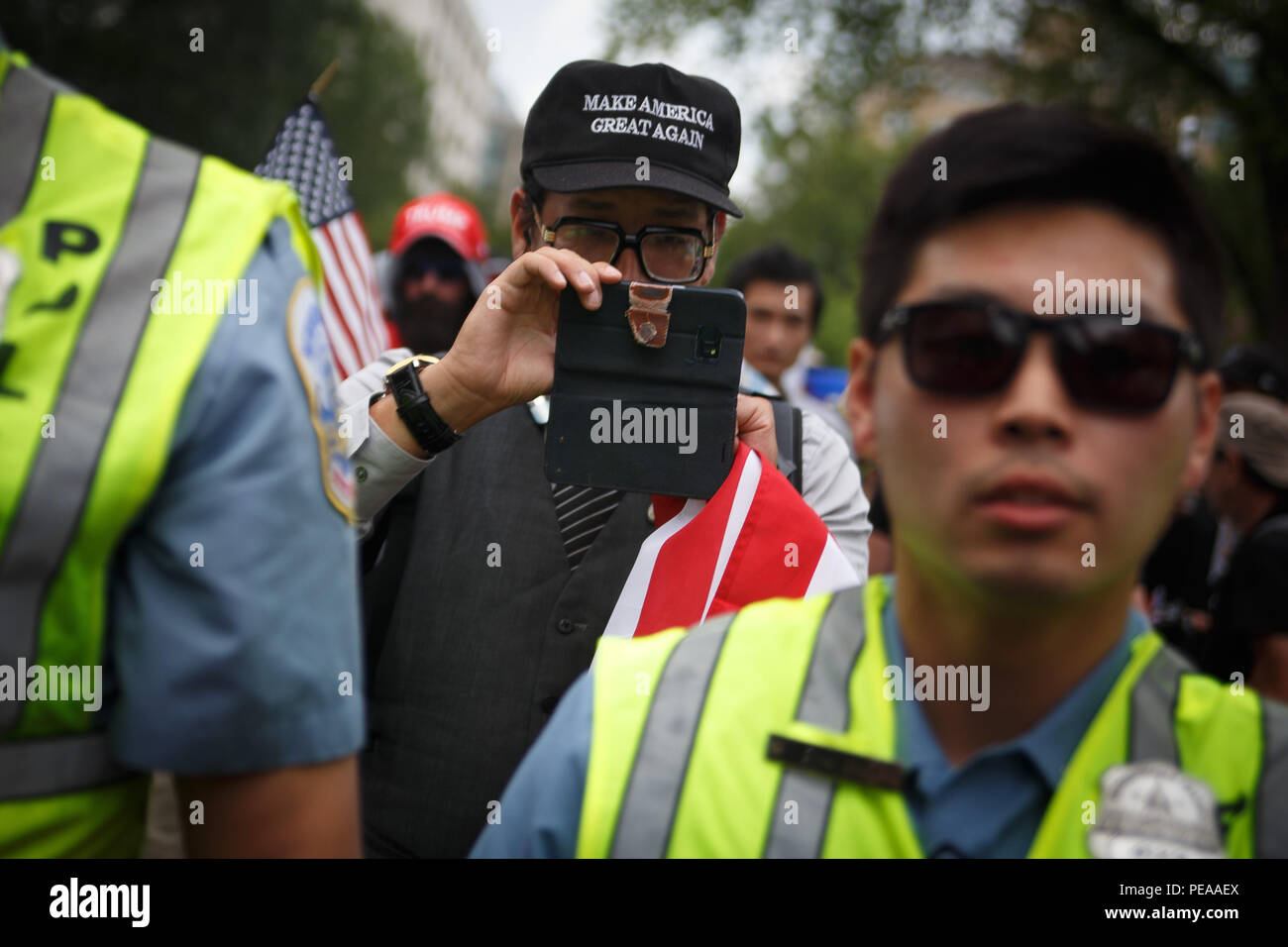 Washington, United States. 12th Aug, 2018. White supremacists, escorted by police, make their way from Foggy Bottom Metro station to Lafayette Park for a Unite the Right event commemtorating the one-year anniversary of the deadly rally in Charlottesville. Credit: Michael Candelori/Pacific Press/Alamy Live News Stock Photo