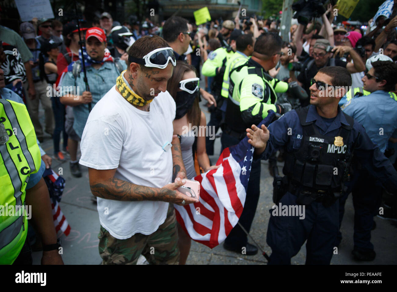Washington, United States. 12th Aug, 2018. White supremacists, escorted by police, make their way from Foggy Bottom Metro station to Lafayette Park for a Unite the Right event commemtorating the one-year anniversary of the deadly rally in Charlottesville. Credit: Michael Candelori/Pacific Press/Alamy Live News Stock Photo