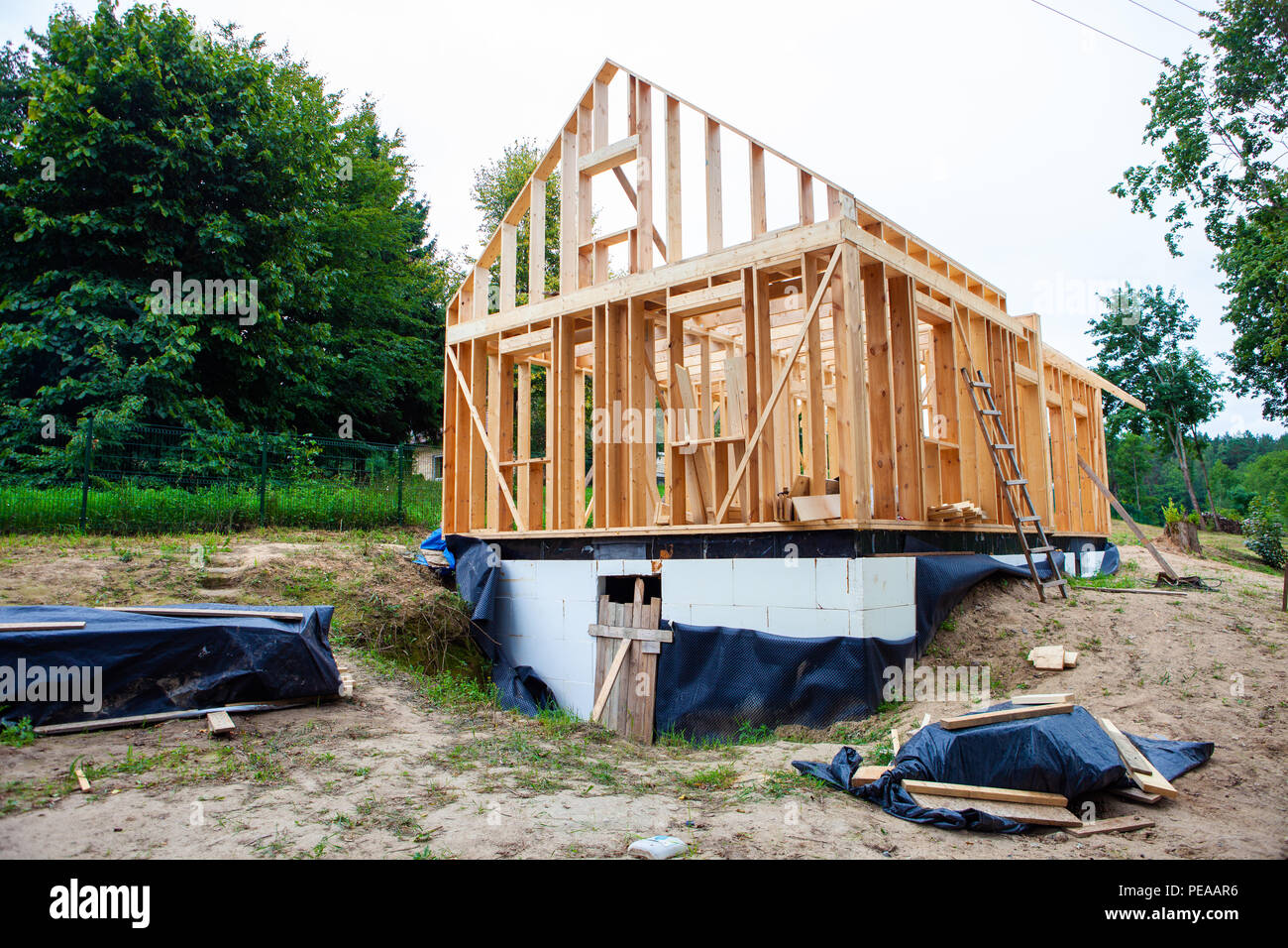 Stick built home under construction, new build roof with wooden truss, post and beam framework, timber frame house, real estate Stock Photo
