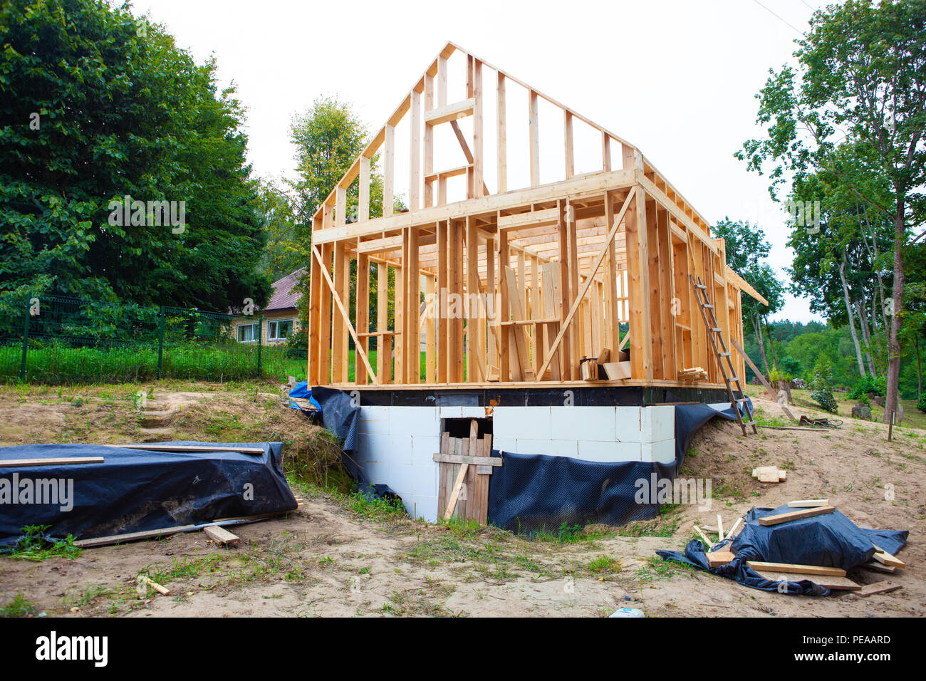 Stick built home under construction, new build roof with wooden truss, post and beam framework, timber frame house, real estate Stock Photo