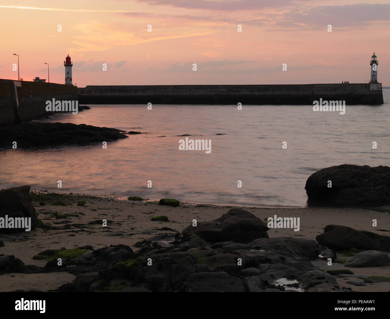 Sunset at Ile-de-Groix in southern Brittany, the harbor with two lighthouses Stock Photo