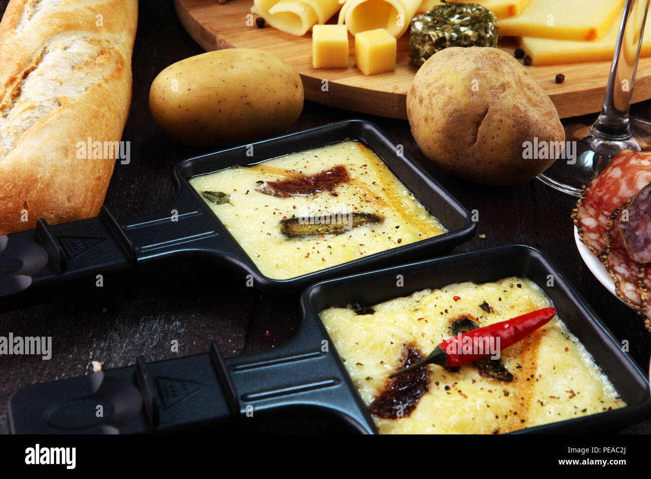 Delicious traditional Swiss melted raclette cheese on diced boiled ...