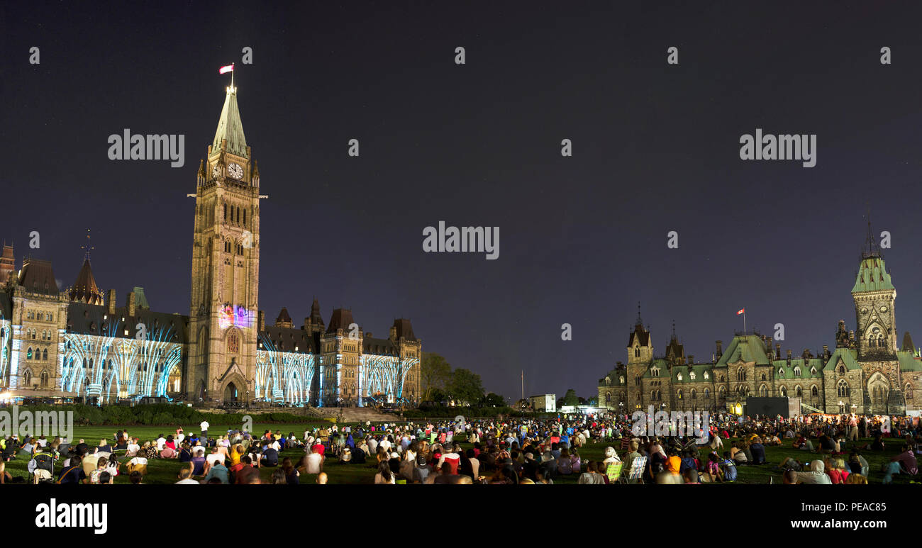 A crowd watches the Northern Lights Sound and Light show on Parliament Hill in Ottawa, Canada. Stock Photo