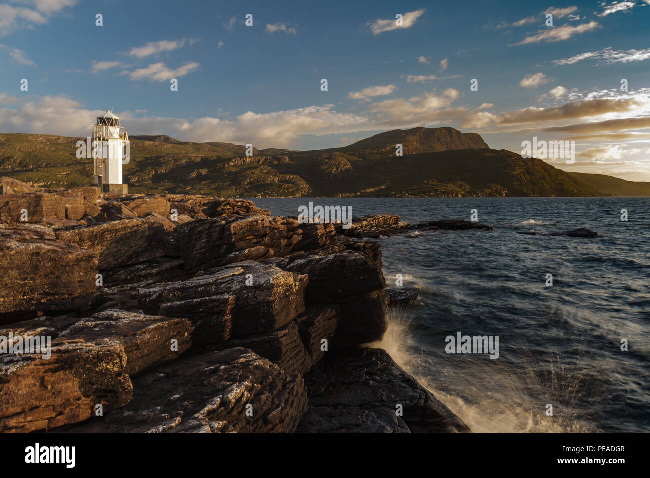 Rhue Lighthouse, Ullapool, Scotland, at sunset in summer Stock Photo