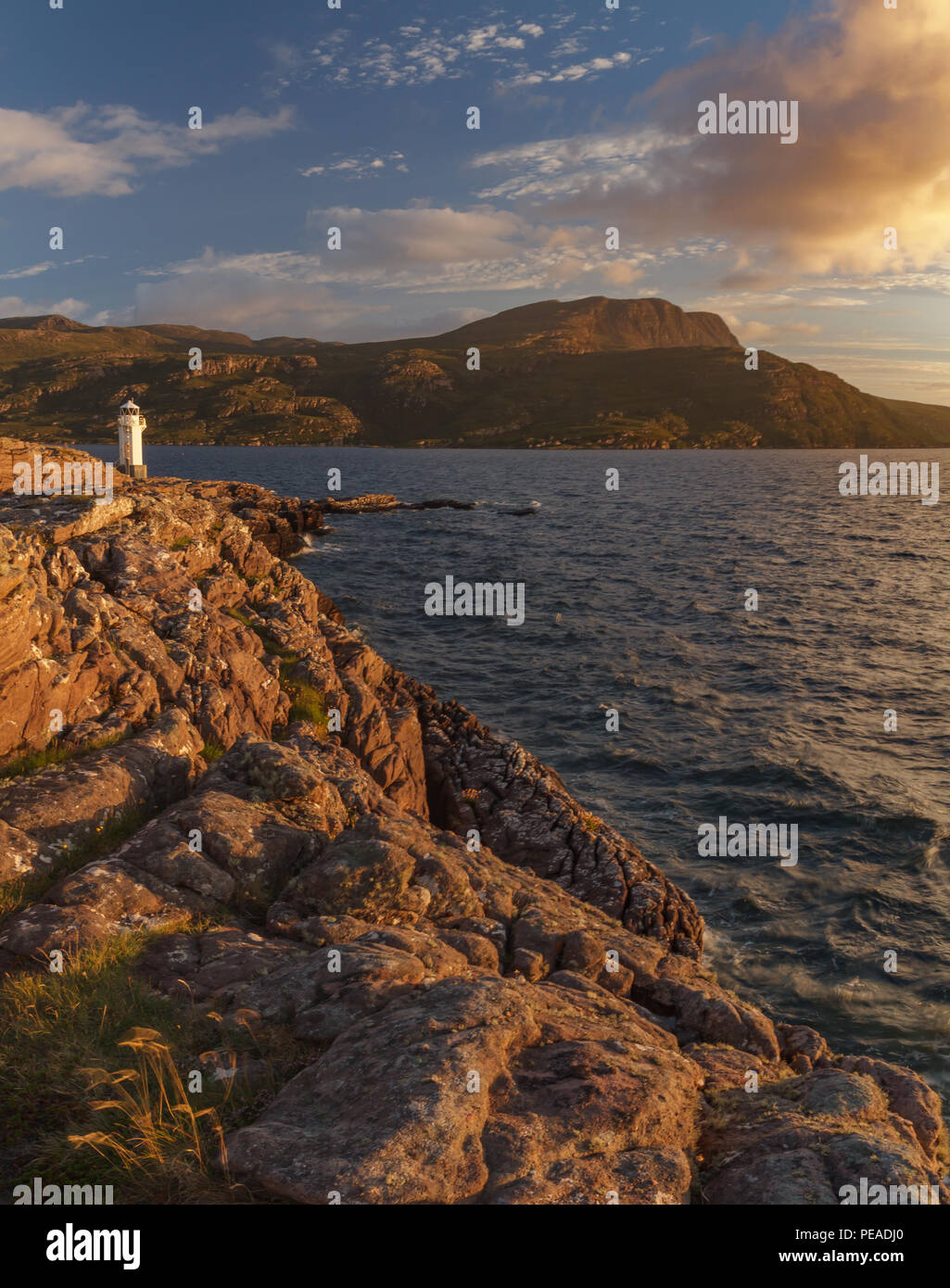 Rhue Lighthouse, Ullapool, Scotland, at sunset in summer Stock Photo