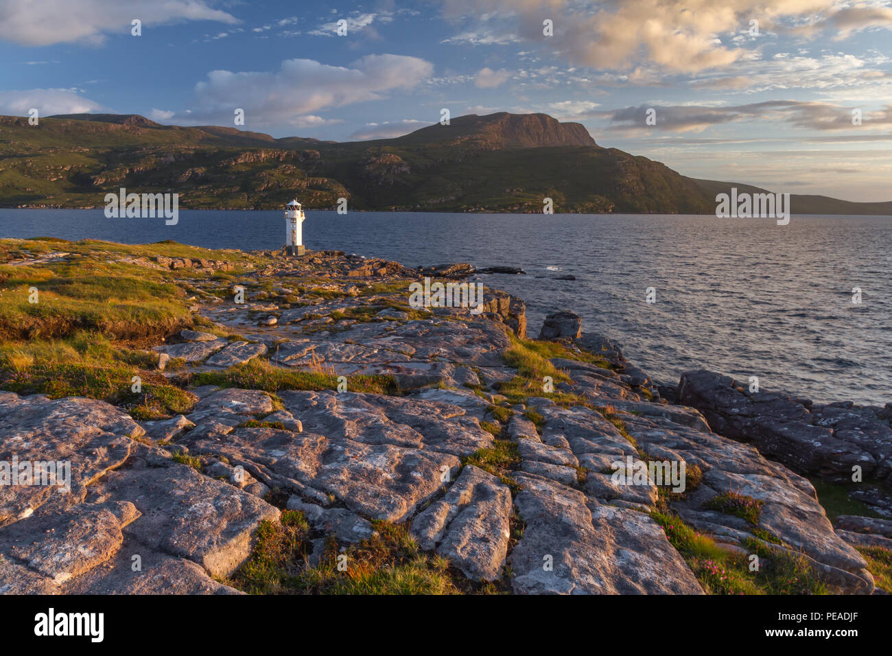 Rhue Lighthouse, Ullapool, Scotland, at sunset in summer Stock Photo