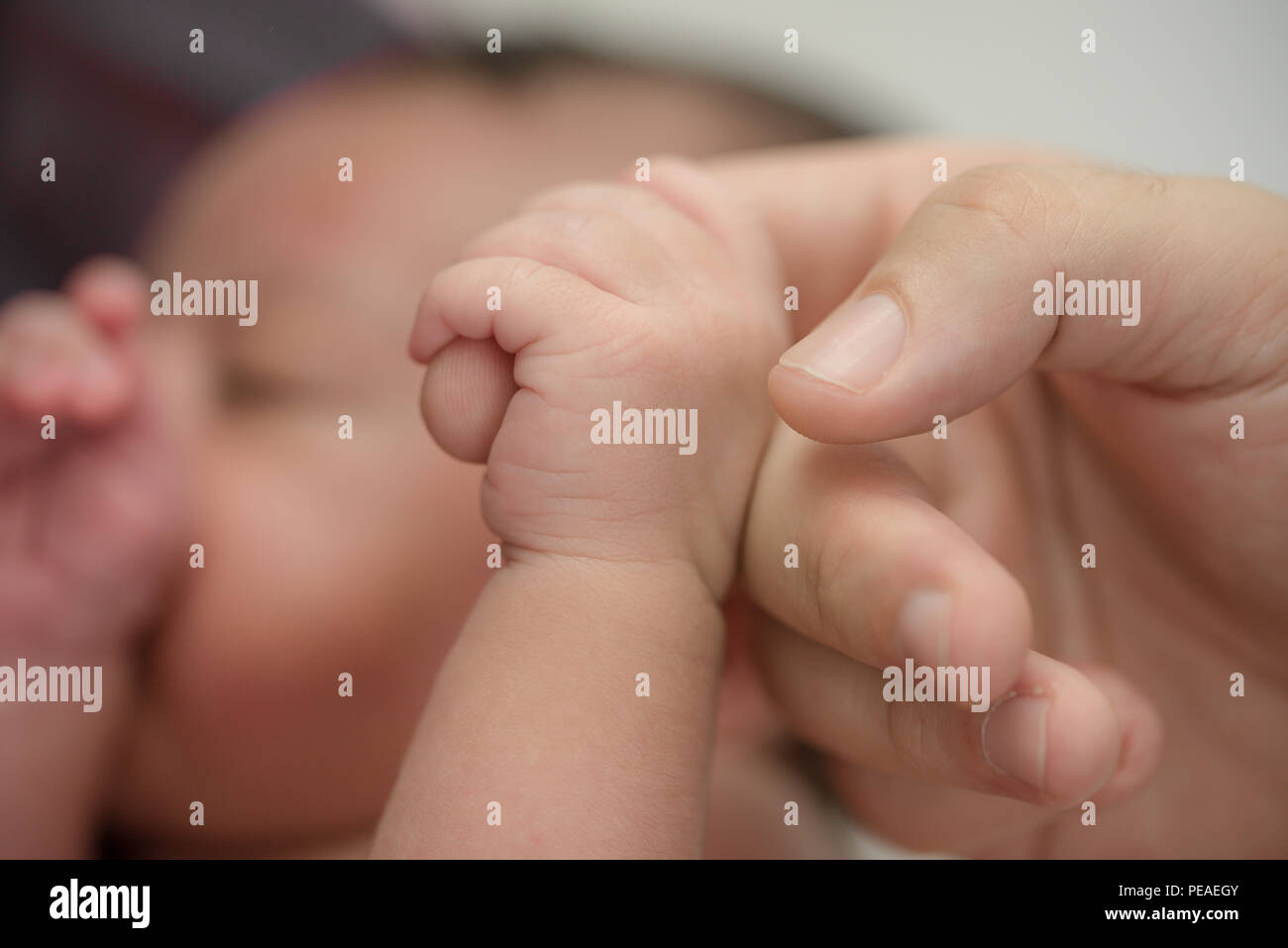 Newborn baby hand holding dads finger Stock Photo by ©Lakschmi 99674088