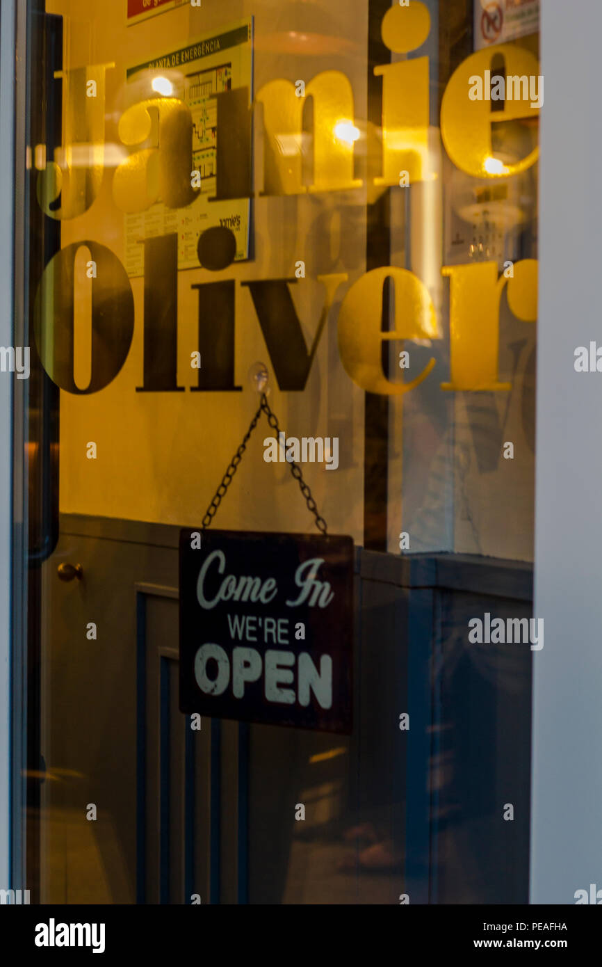 Business open sign on Jamie Oliver restaurant door Stock Photo