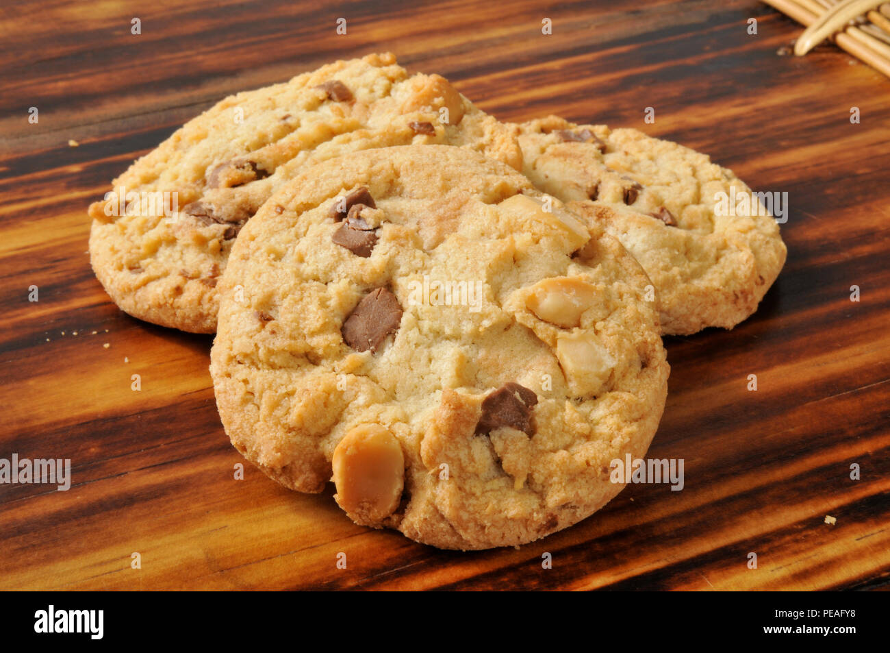 Three white and dark chocolate chip cookies with macadamia nuts Stock Photo