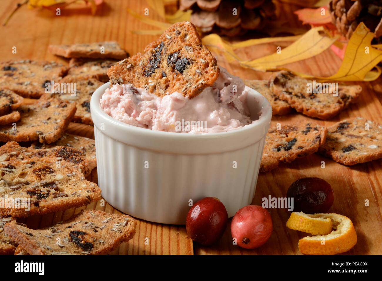 Cranberry orange cheese spread with fruit and nut crackers Stock Photo