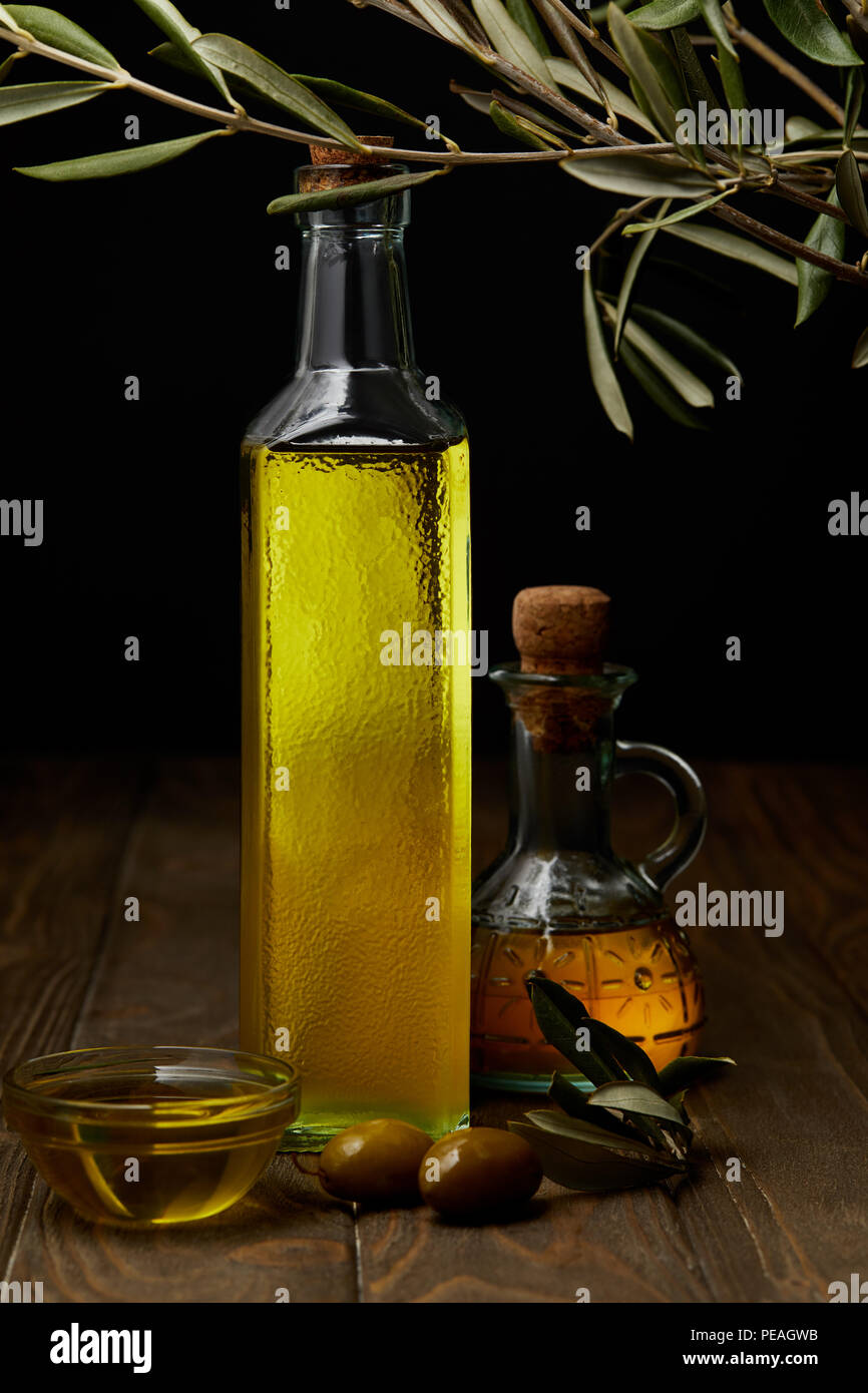 bottles of olive oil on wooden tabletop Stock Photo Alamy